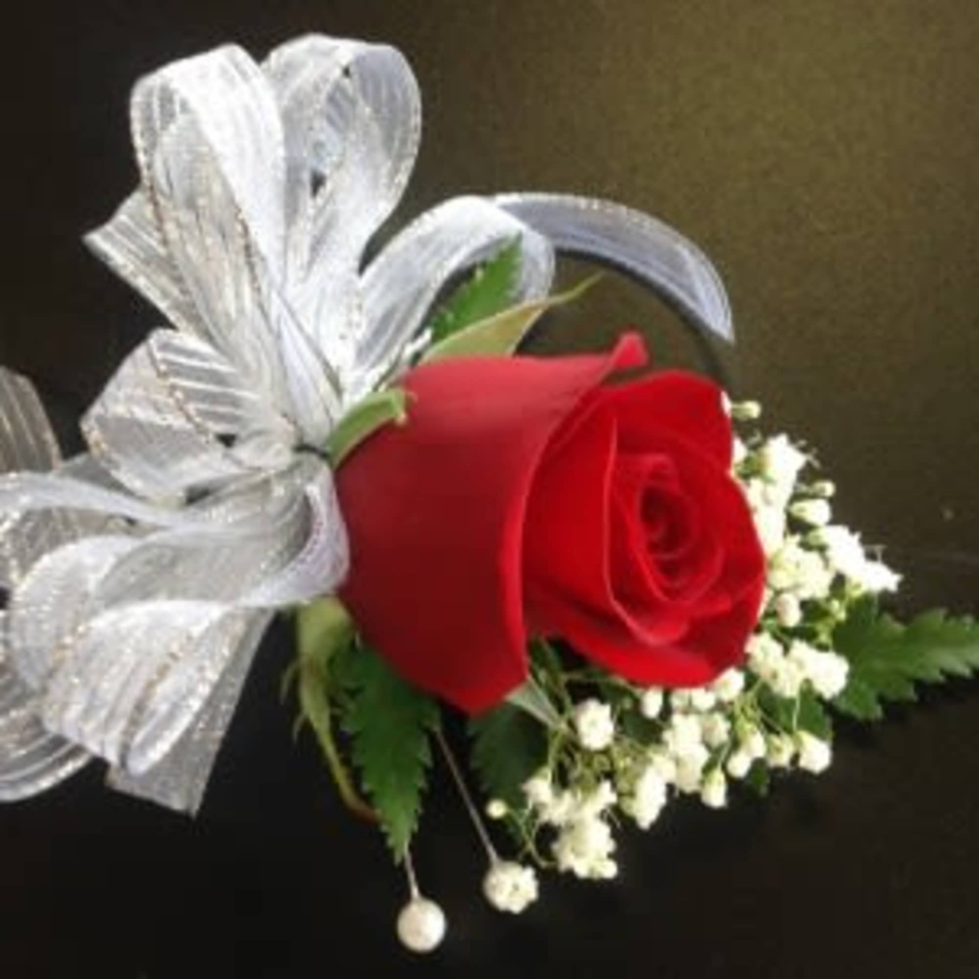Red rose boutonniere with white baby's breath and silver ribbon