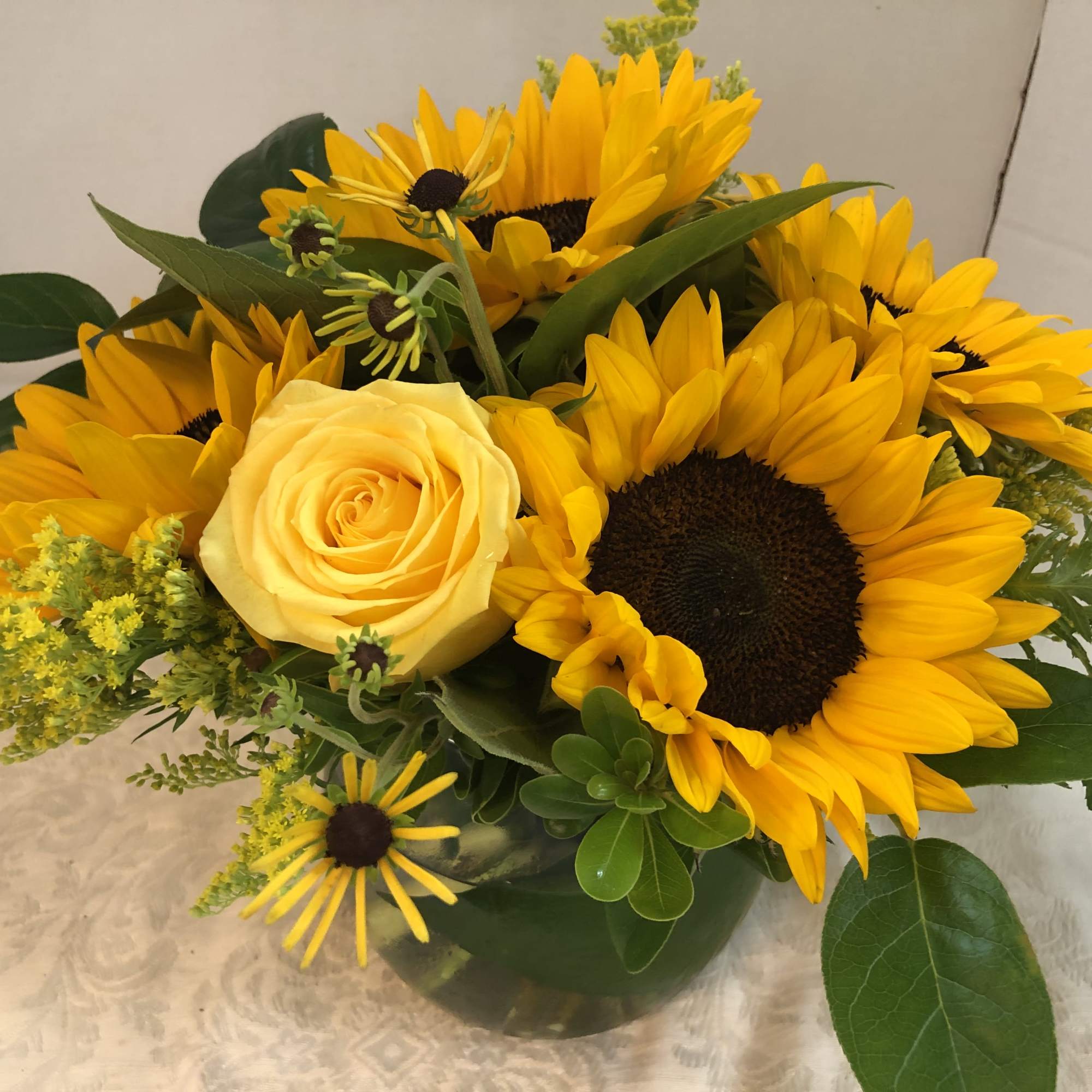 Sunflowers, Roses, Touch of Summer, Solidago, Fancy Greens.

Note:   There are