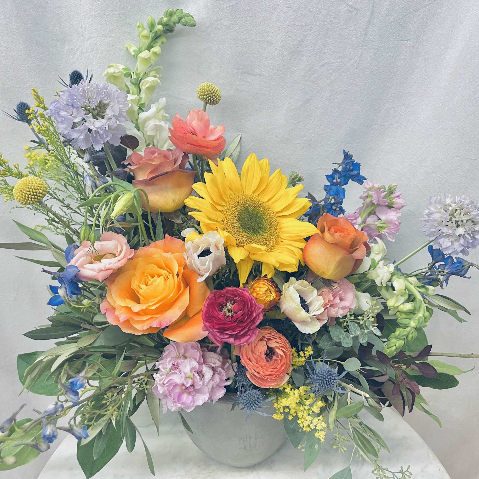 Colorful mixed flower arrangement in a round vase