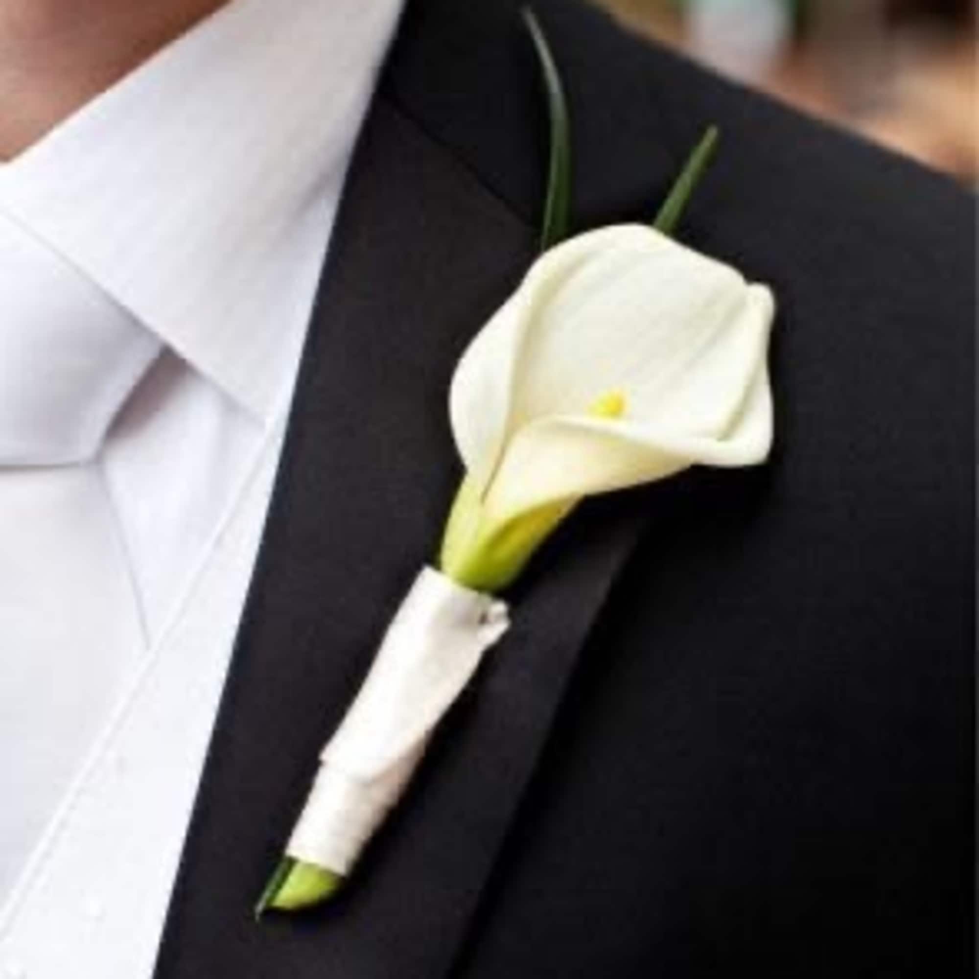White calla lily boutonniere on a black suit lapel