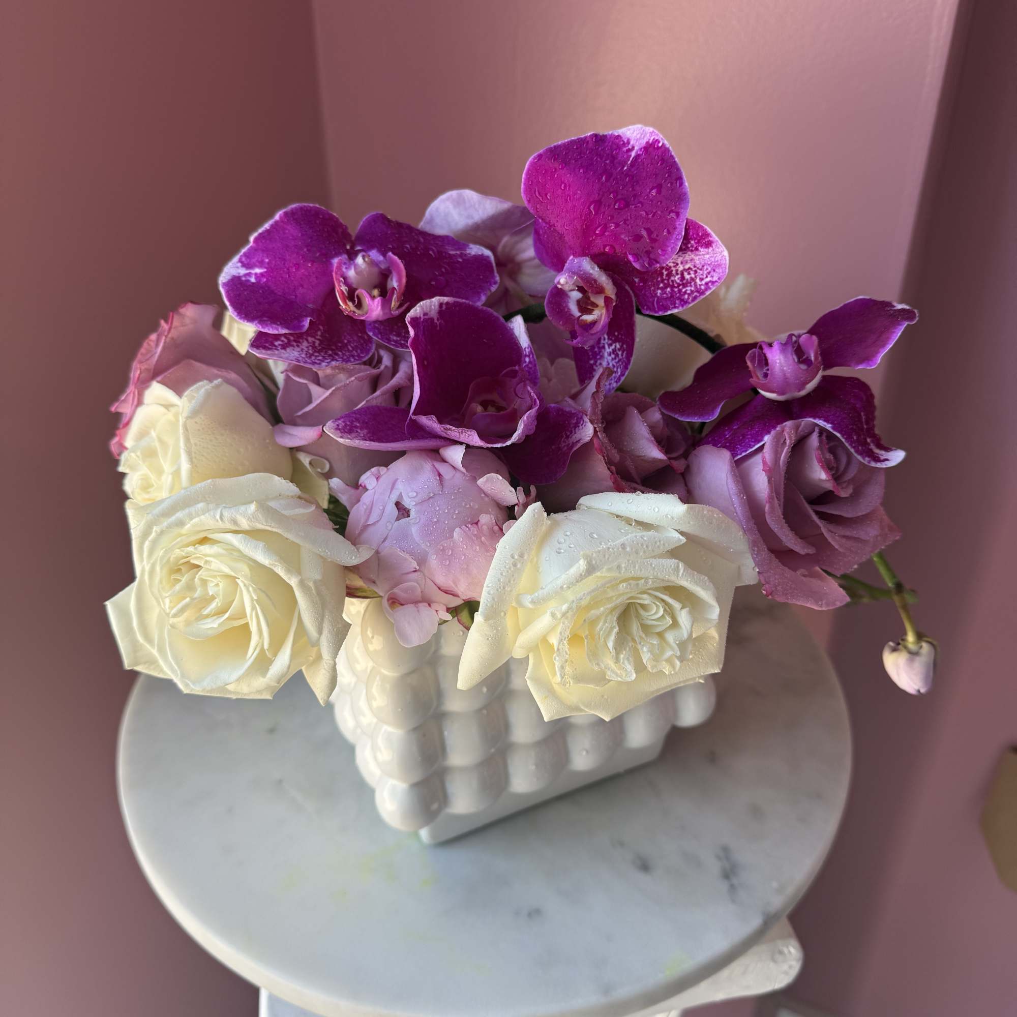 Pink and white roses with purple orchids in a white vase, photo 2 of 2