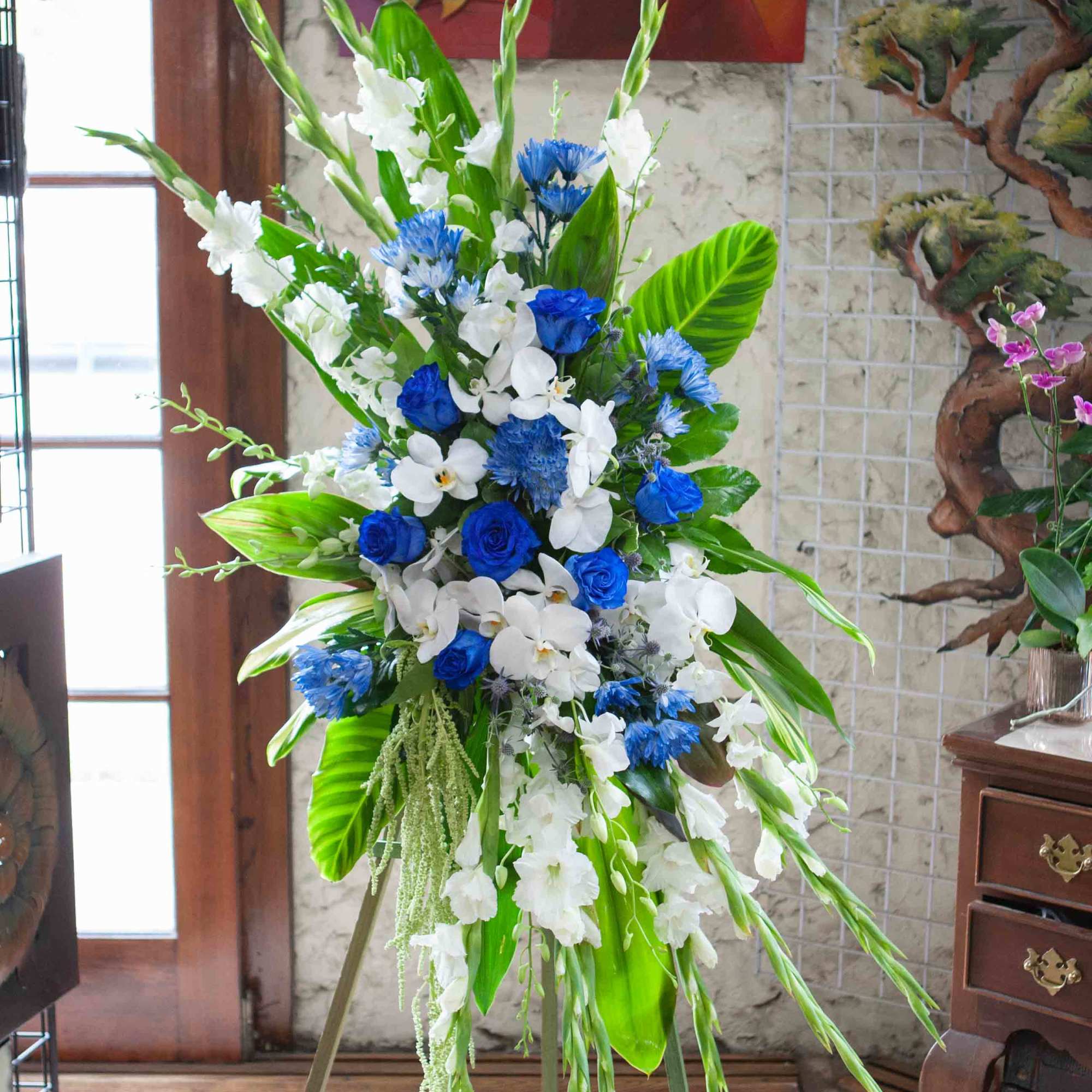 Tall blue and white floral spray on an easel