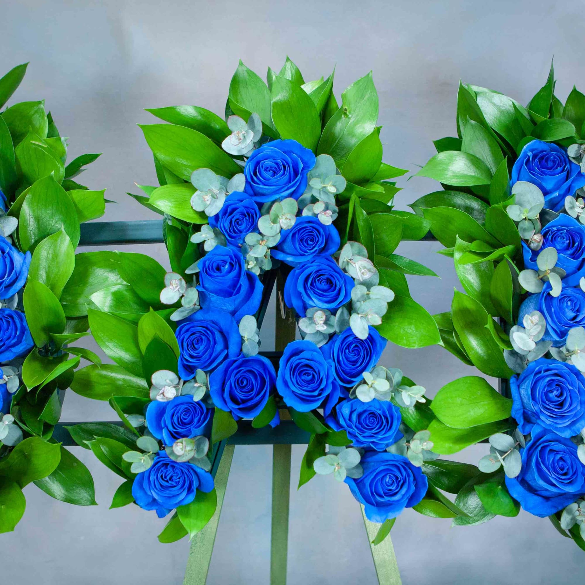 Blue rose floral letters with green leaves and eucalyptus