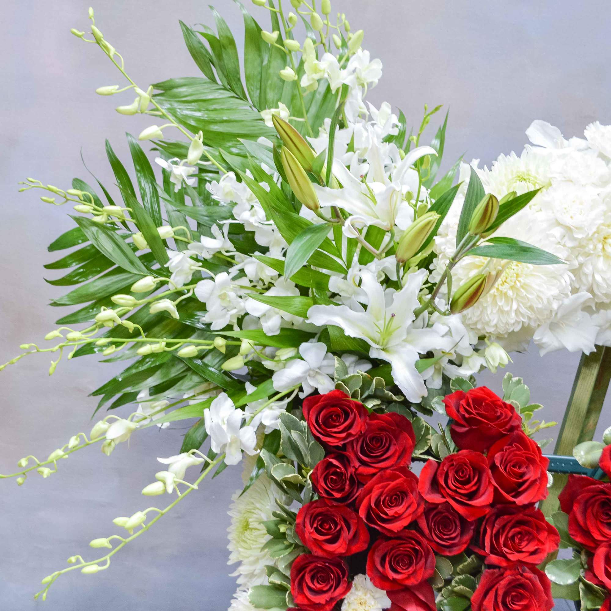 White lilies and chrysanthemums with red roses in floral arrangements