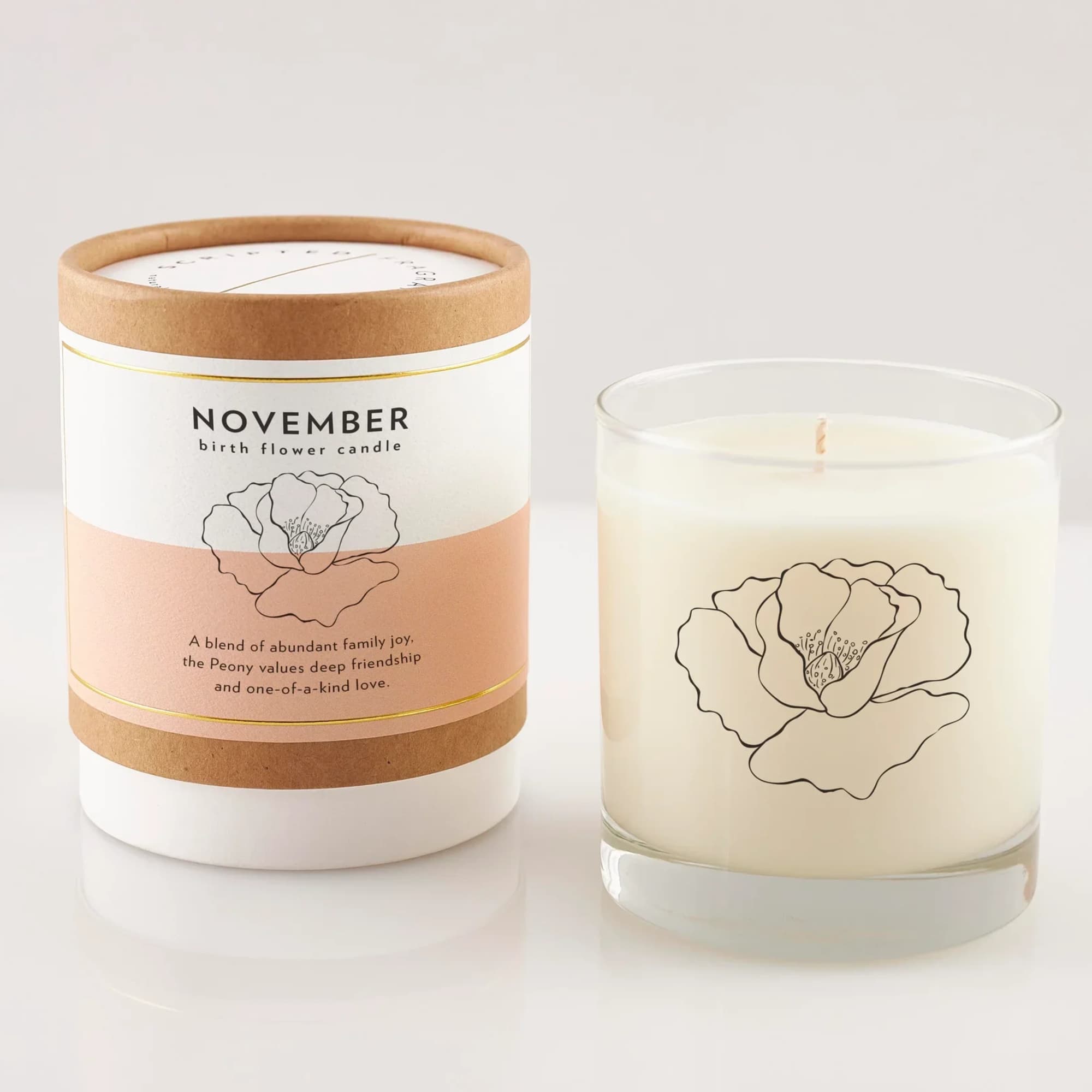 Two peony-scented candles, one in a glass jar and one in a labeled box