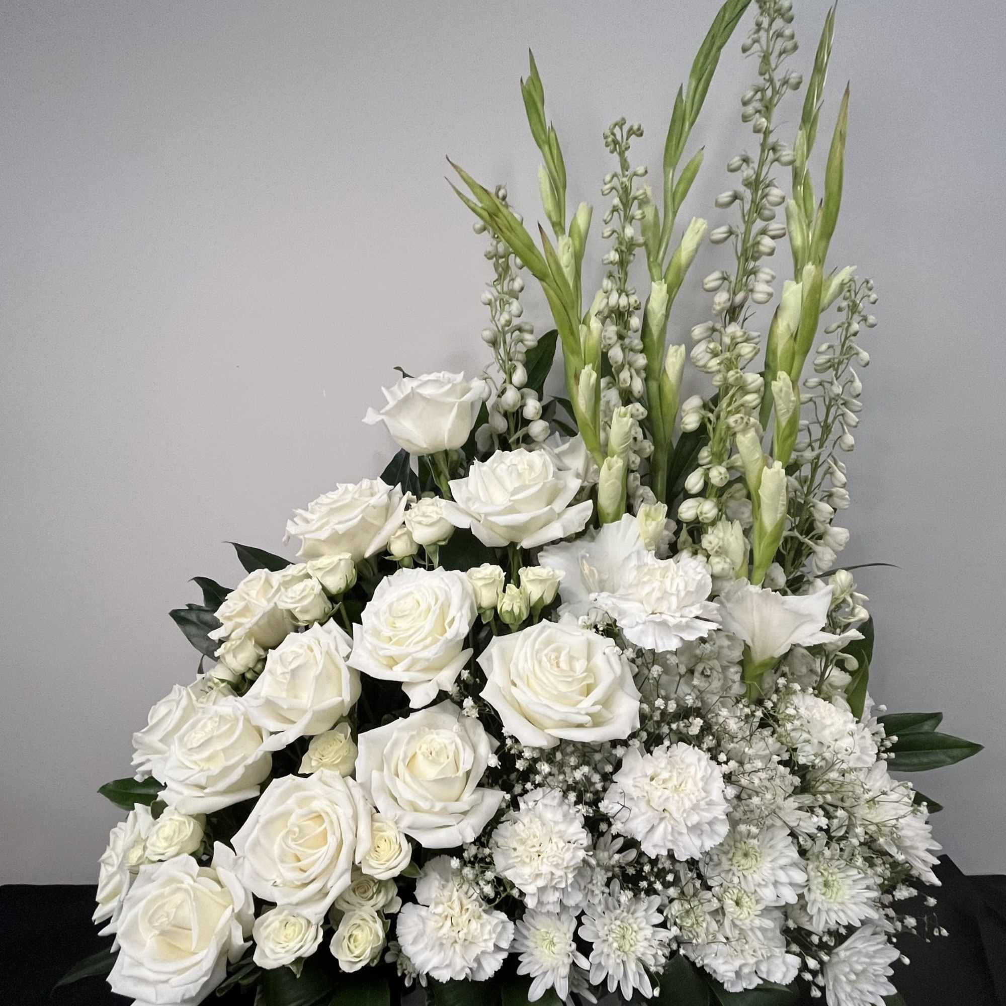 Eternal Light is a graceful all-white arrangement that symbolizes peace, remembrance, and