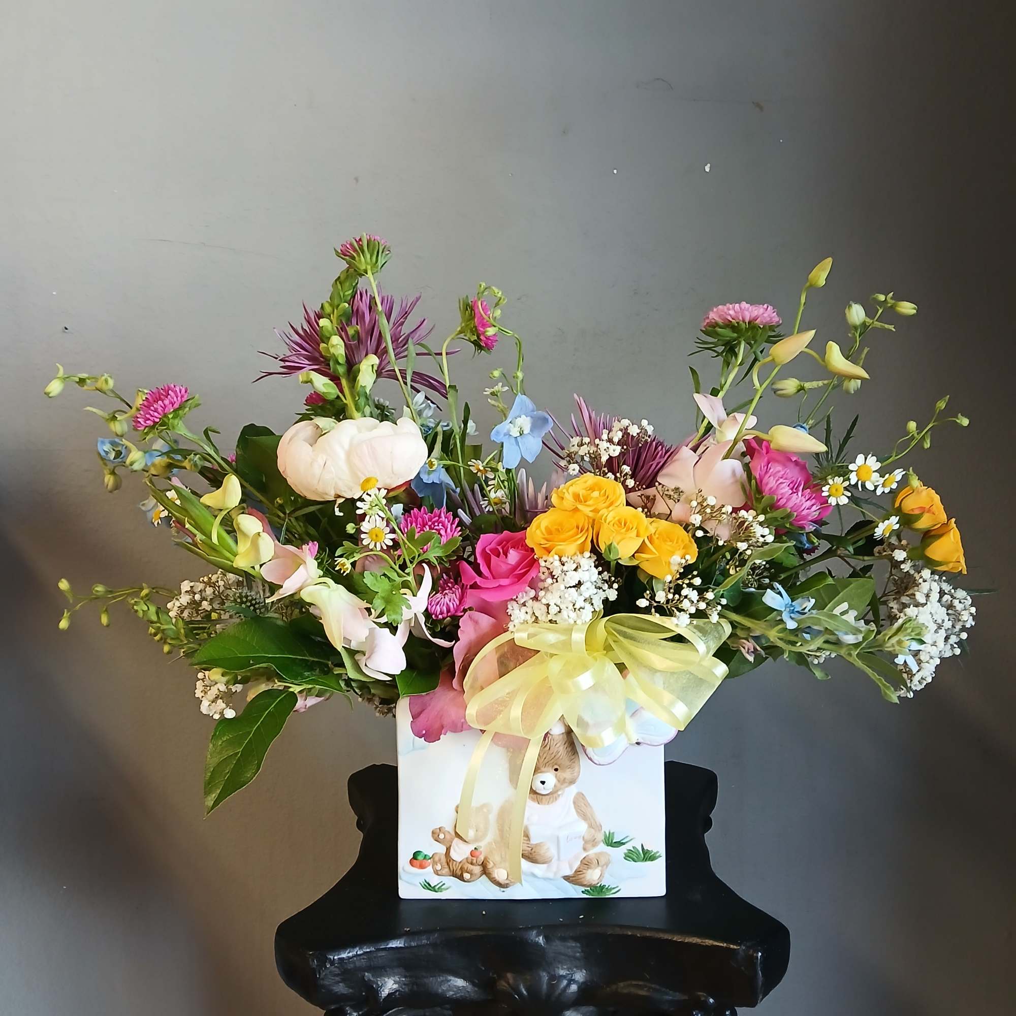 Colorful mixed bouquet in a white gift box with a yellow ribbon