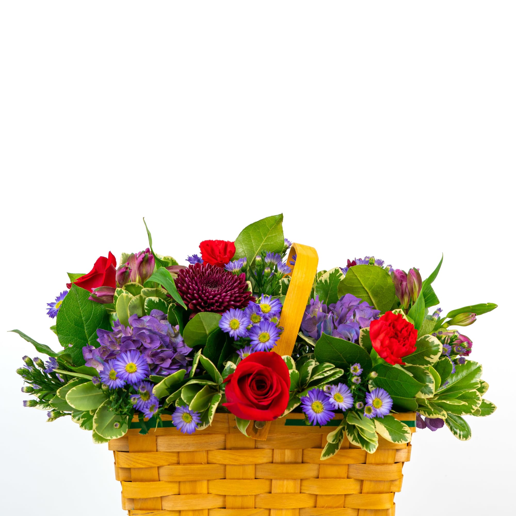 Mixed bouquet in a woven basket with red and purple flowers