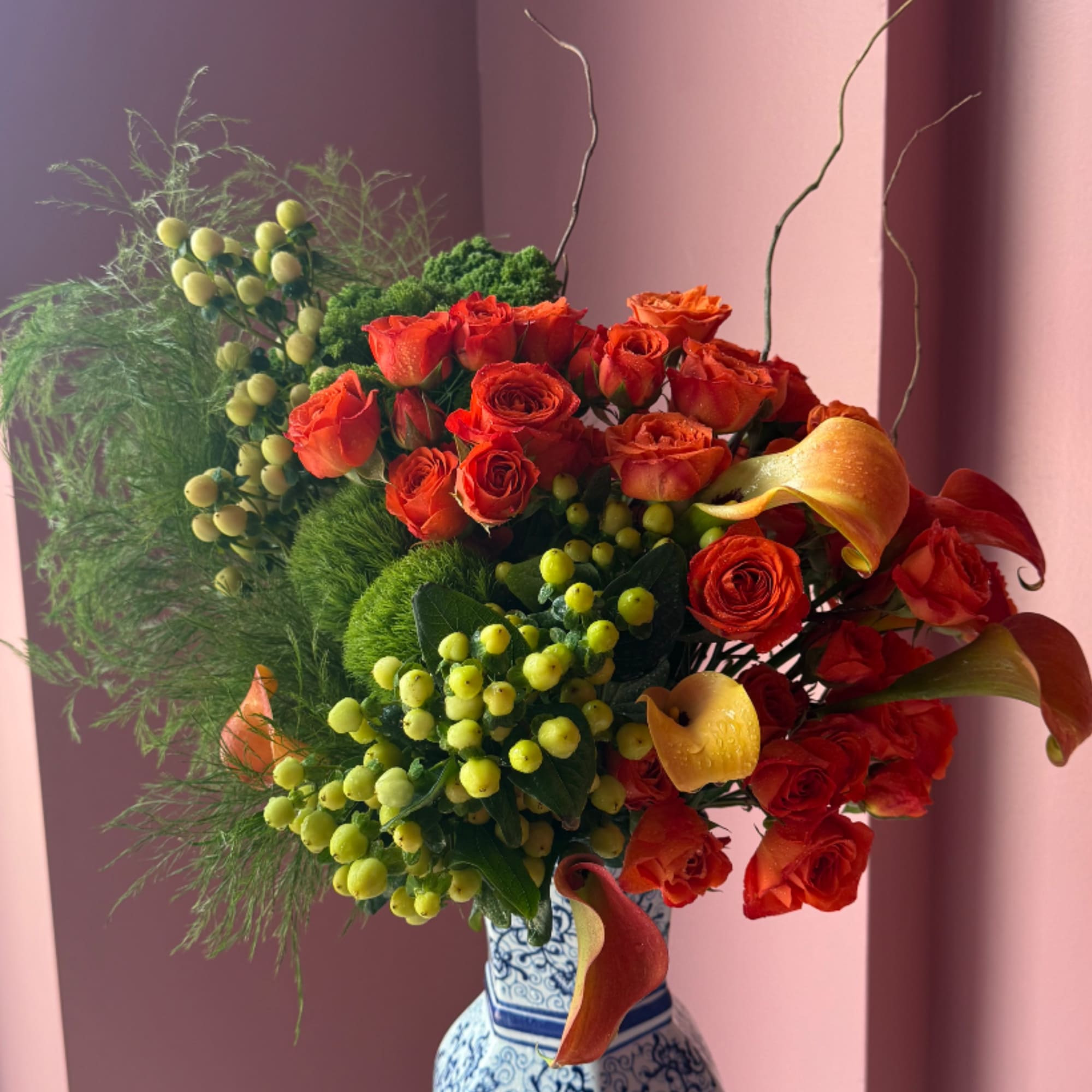 Autumn glimmer is a quintessential fall arrangement featuring a gold architecture vase