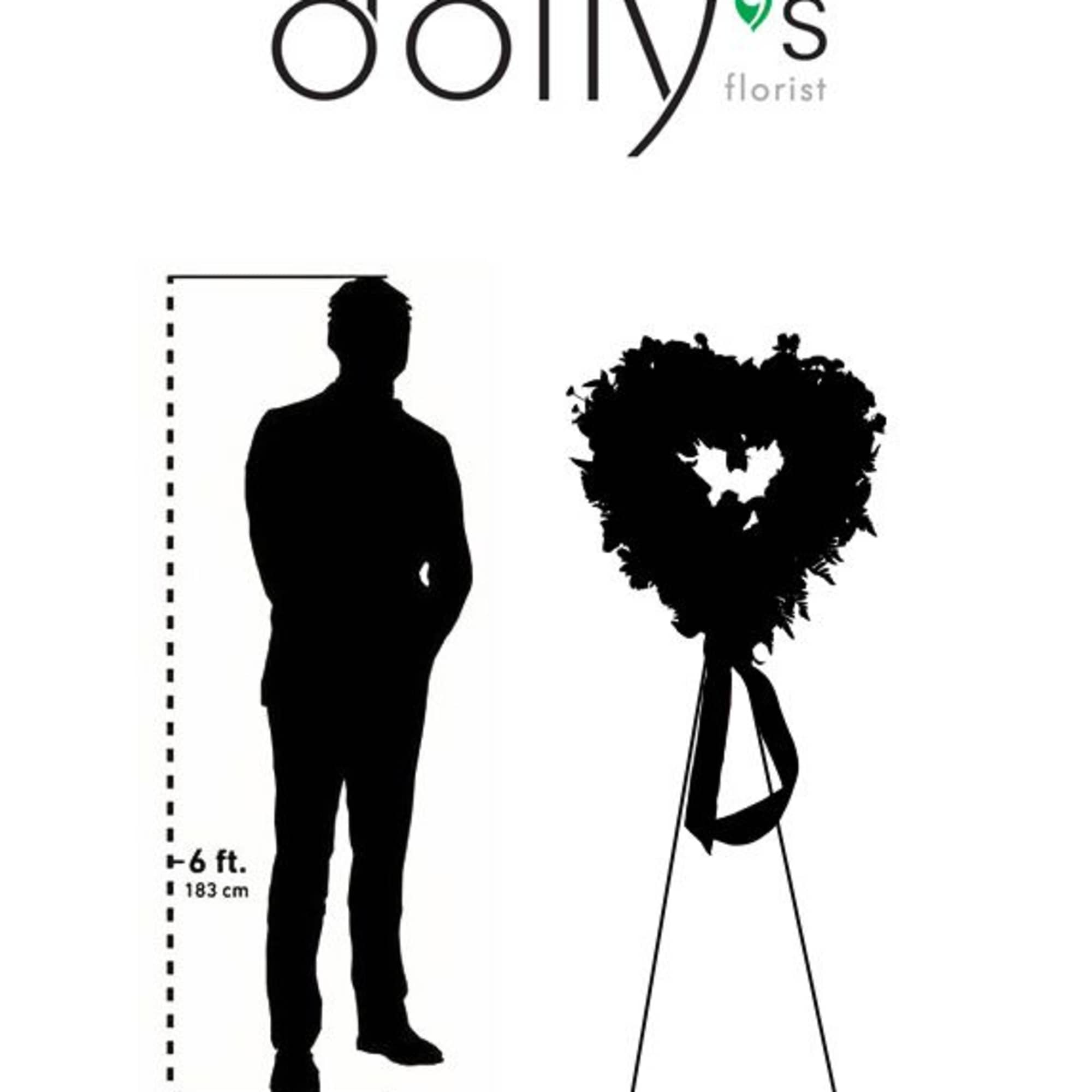 Heart-shaped floral wreath on a stand beside a human height silhouette