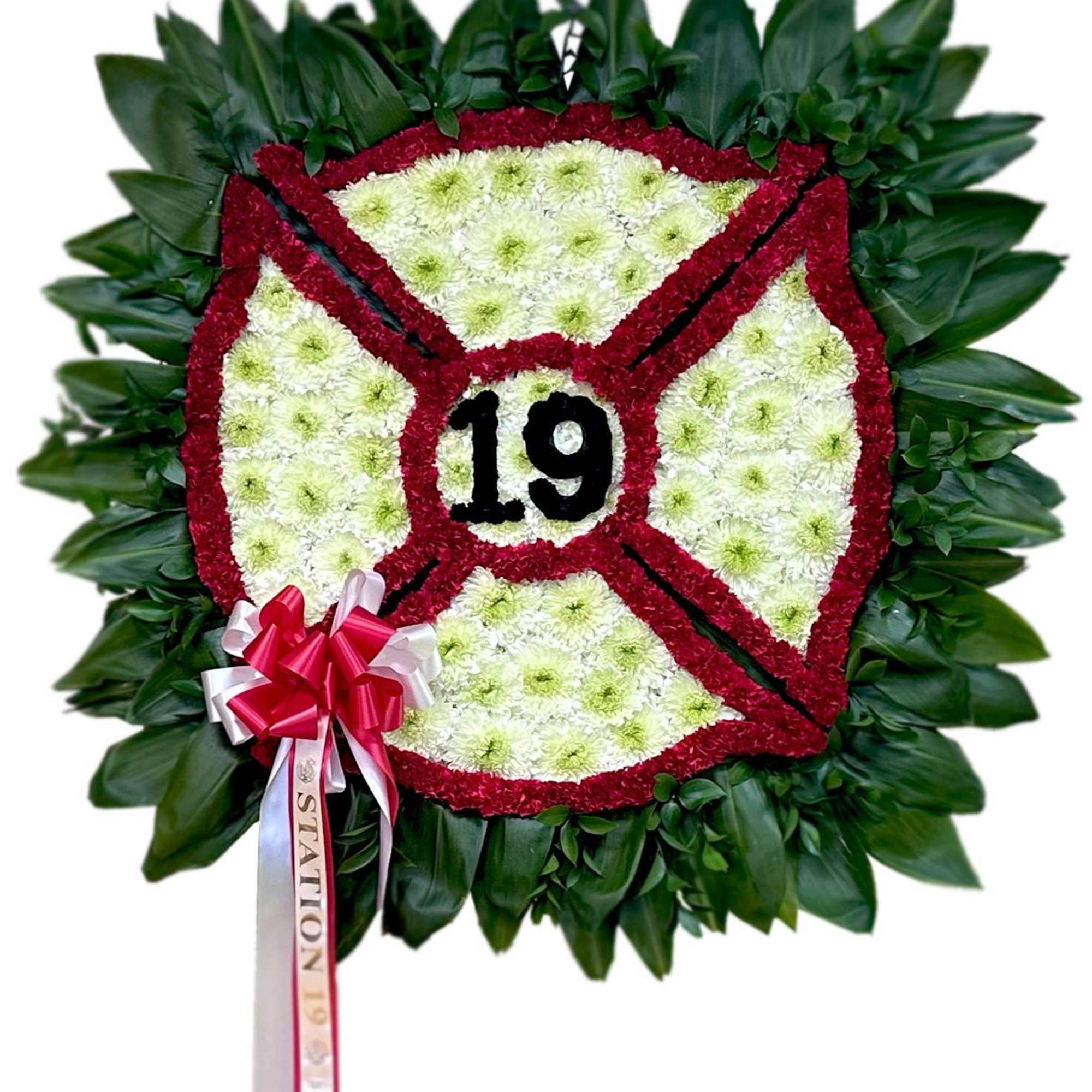 Round floral wreath with the number 19 and a red-white ribbon