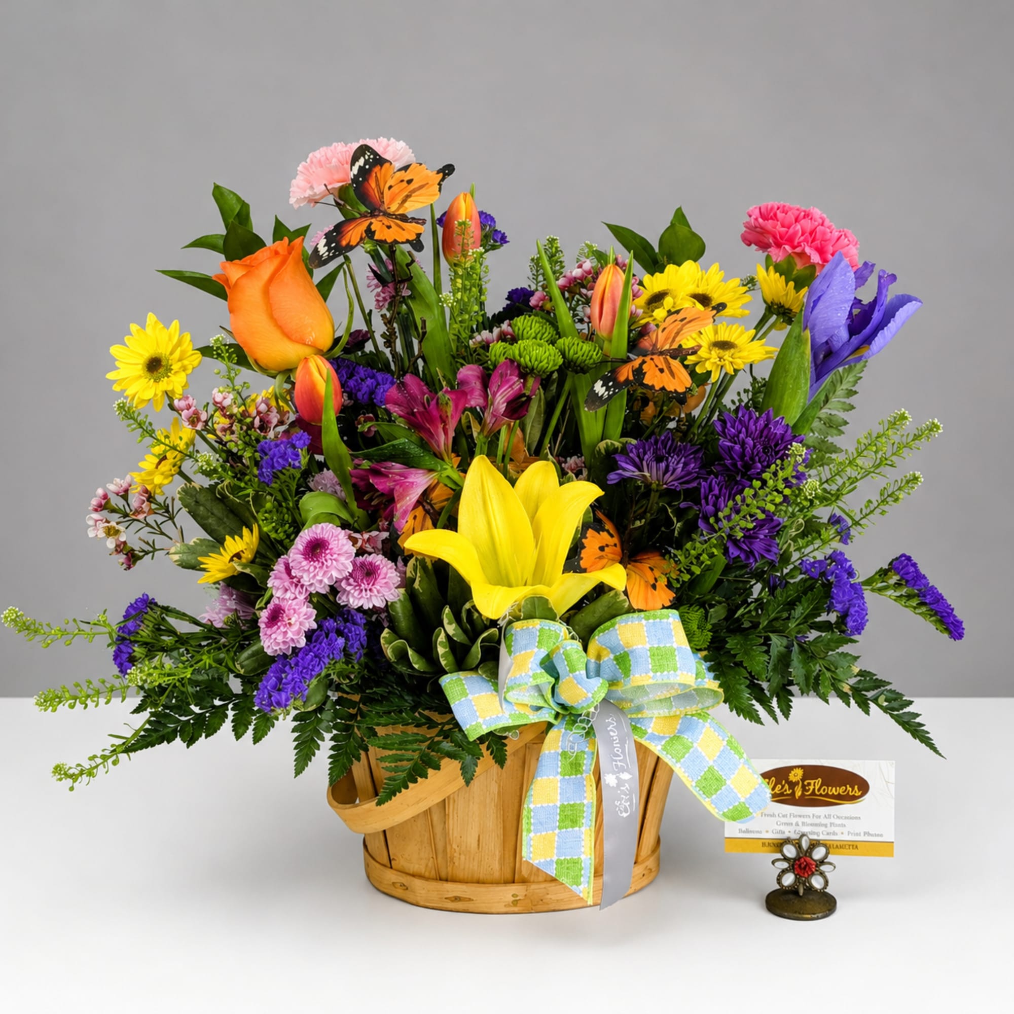 Colorful mixed flower basket with a yellow lily and orange rose
