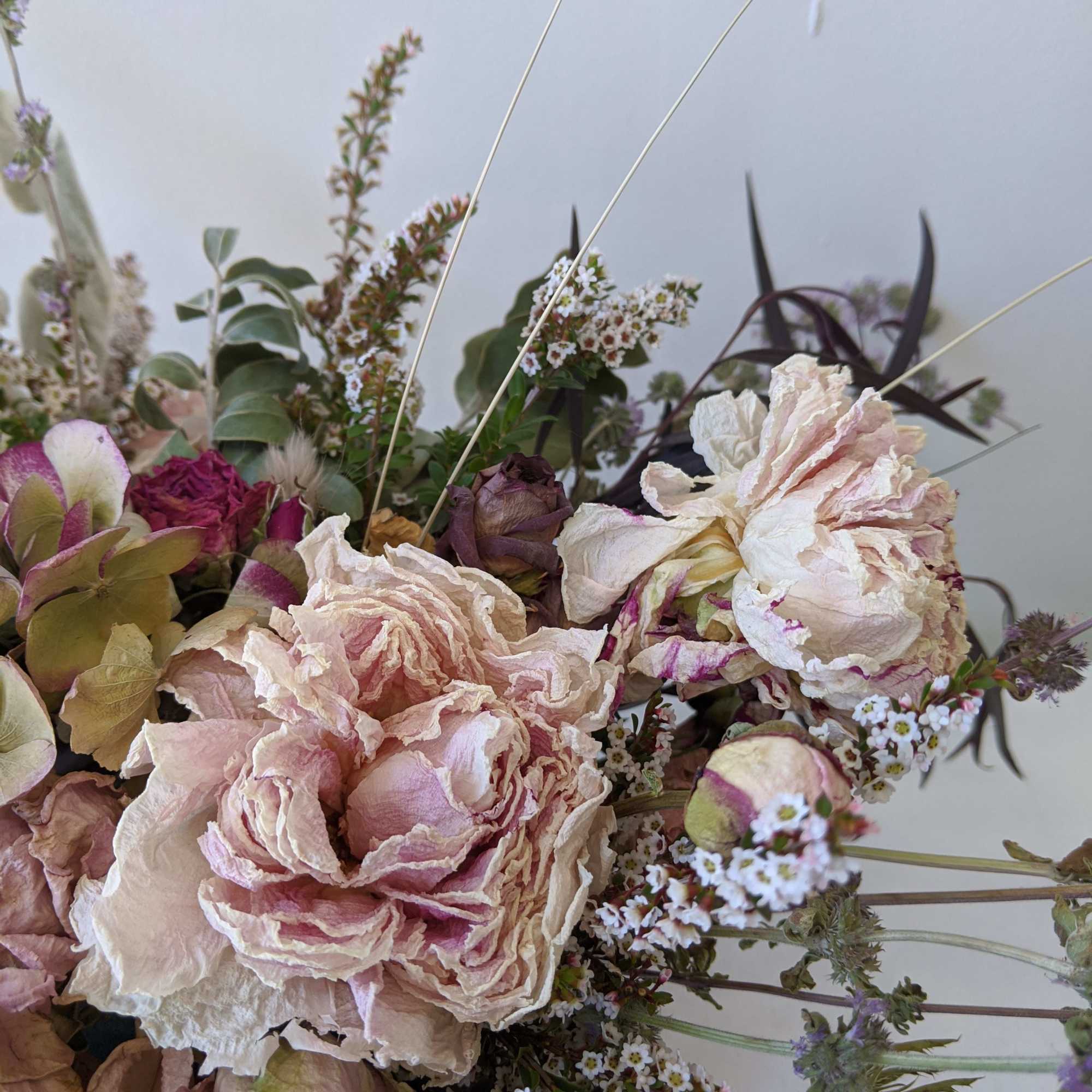 Bouquet of pale pink and cream flowers with small white filler blooms