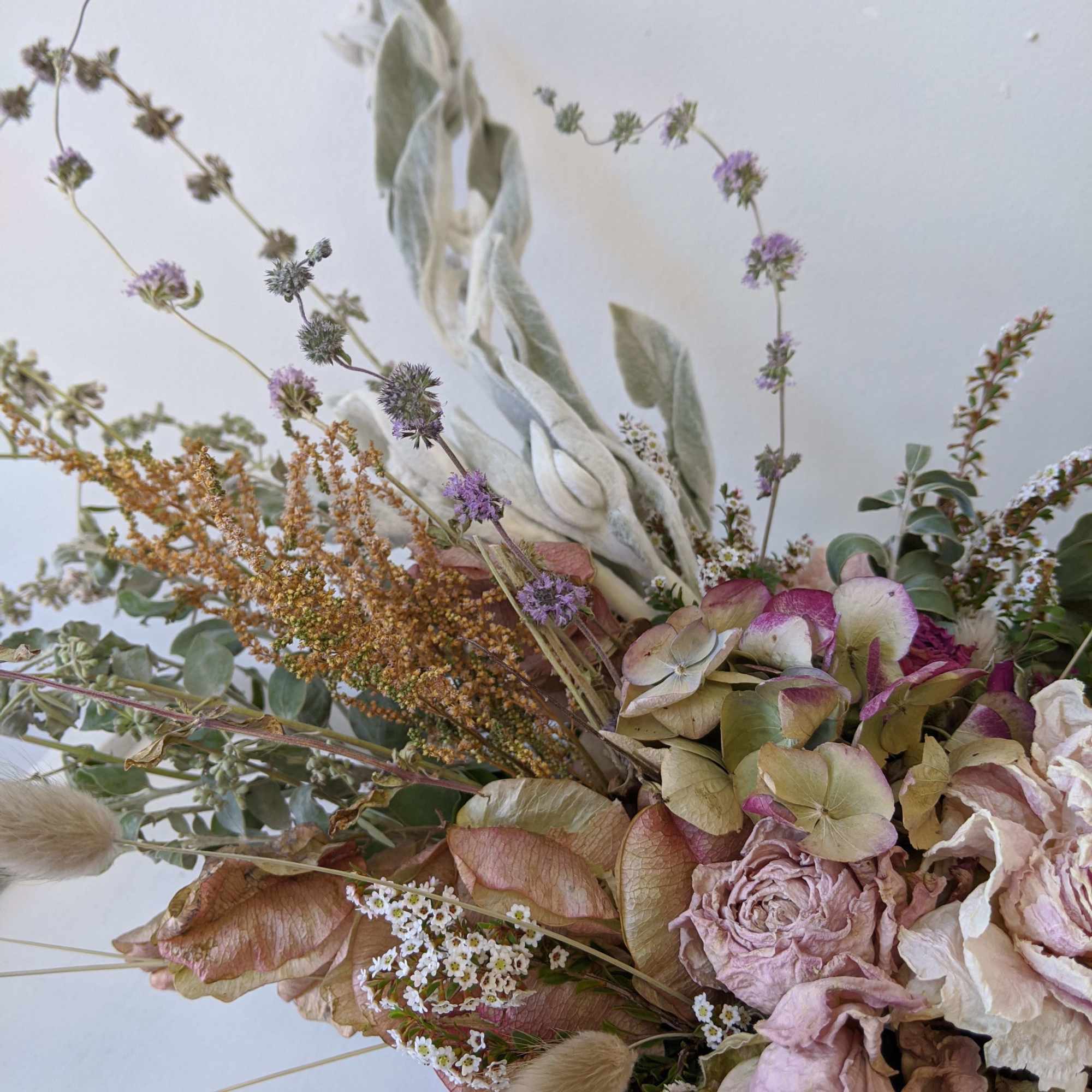 Dried bouquet with pale roses, hydrangea, and airy filler flowers