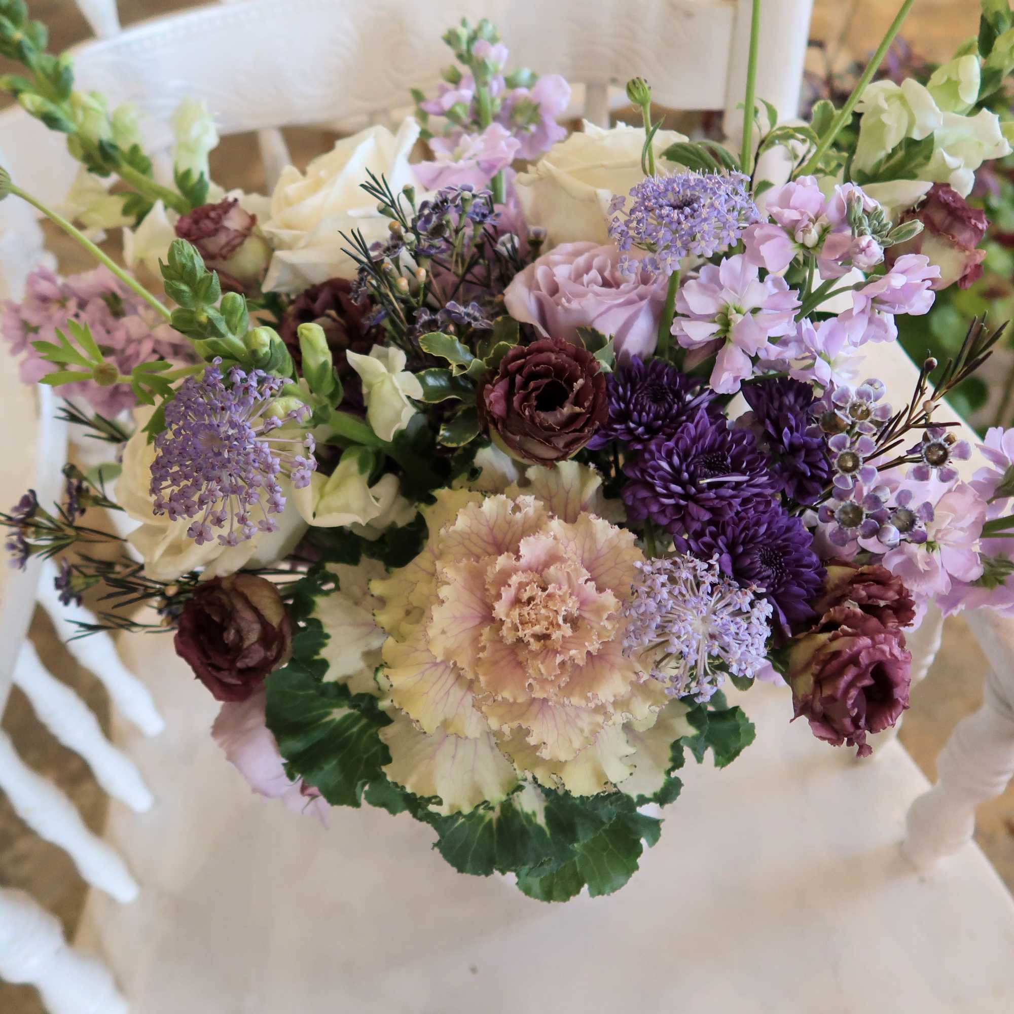 Bouquet of cream, lavender, and burgundy flowers