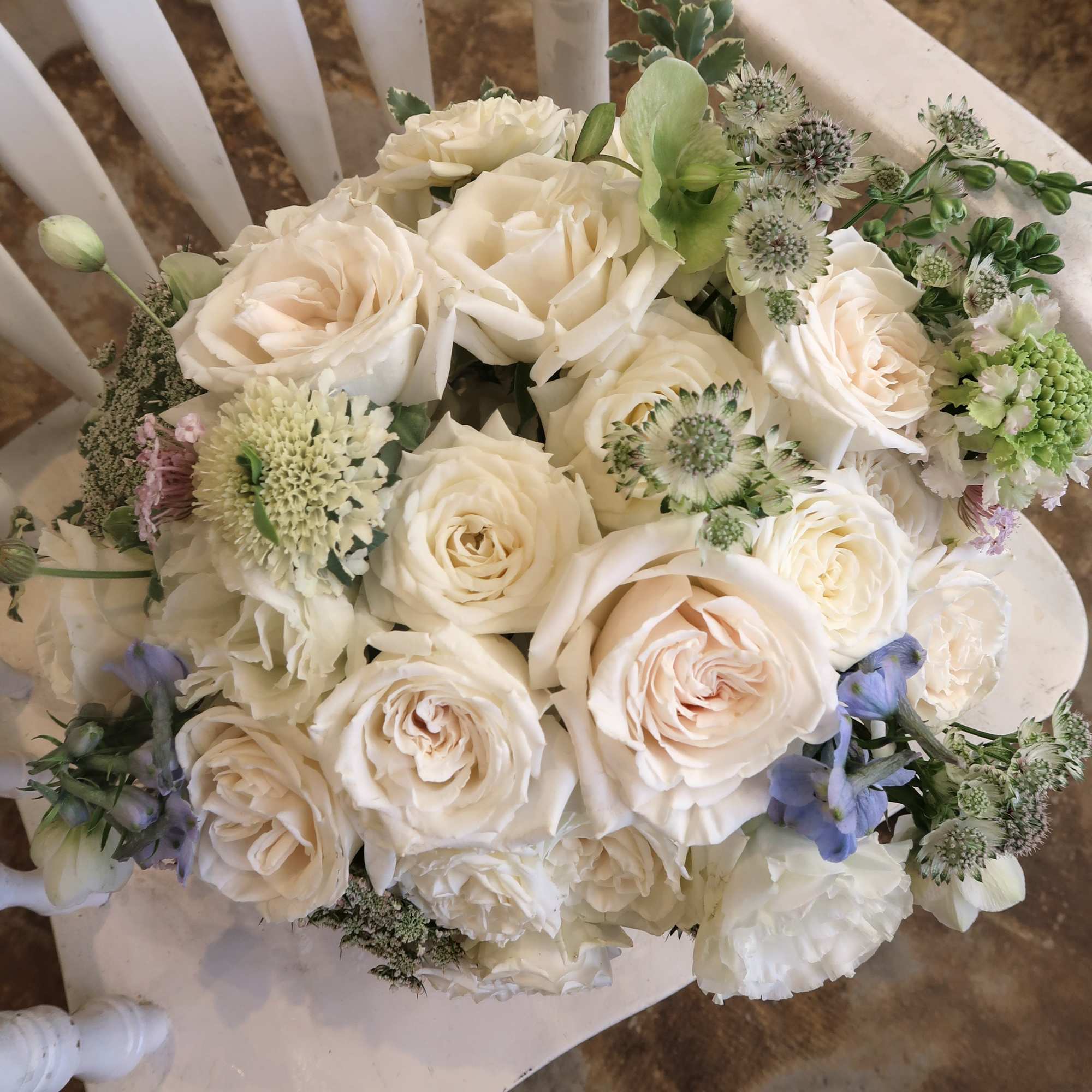 Cream rose bouquet with pale green and lavender accent flowers