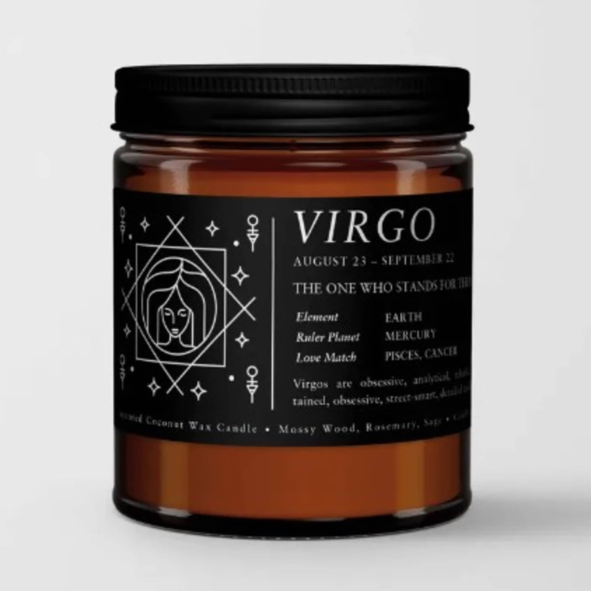 Amber candle in a glass jar with a black Virgo label