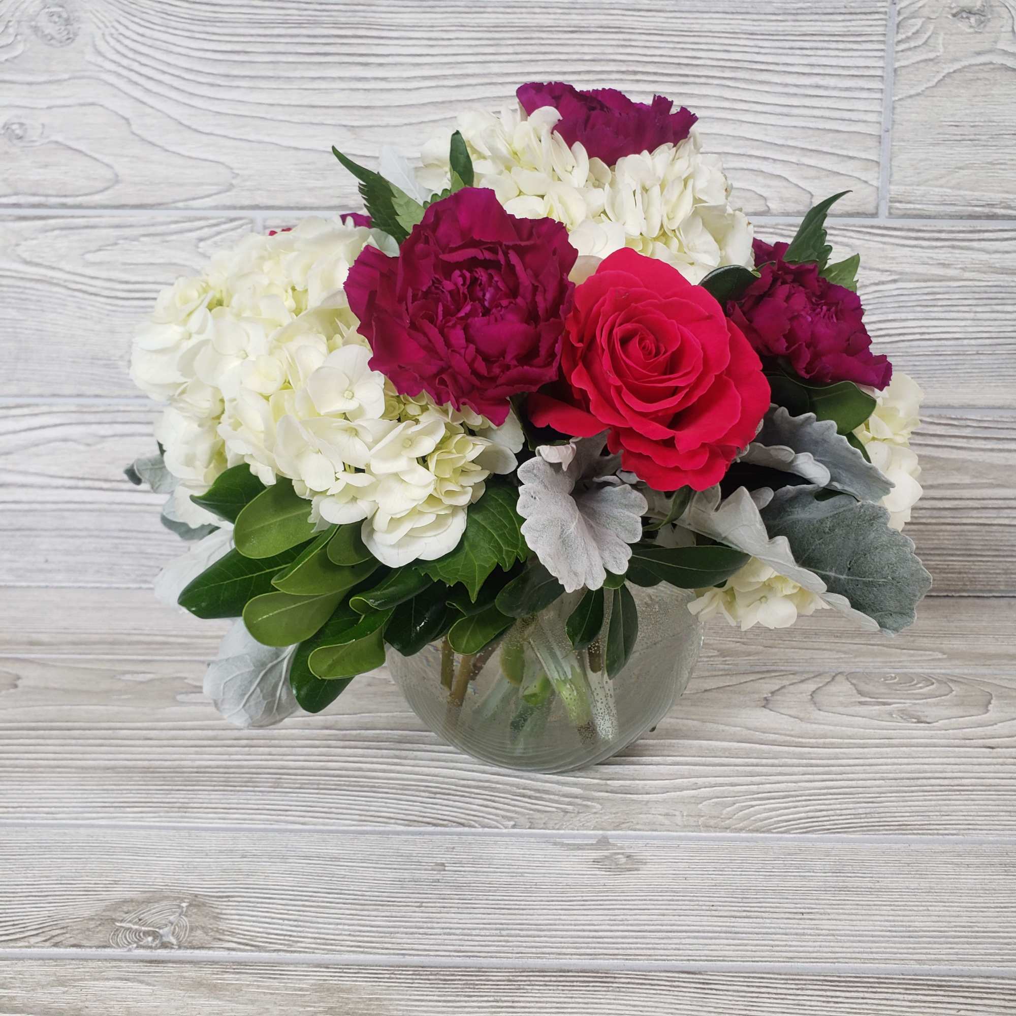 Pink roses and white hydrangeas in a glass vase