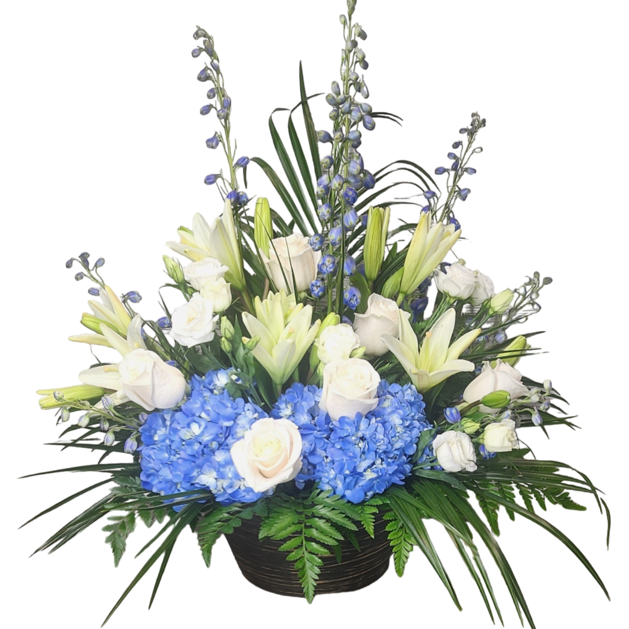 Blue hydrangeas and white lilies with roses in a black bowl vase