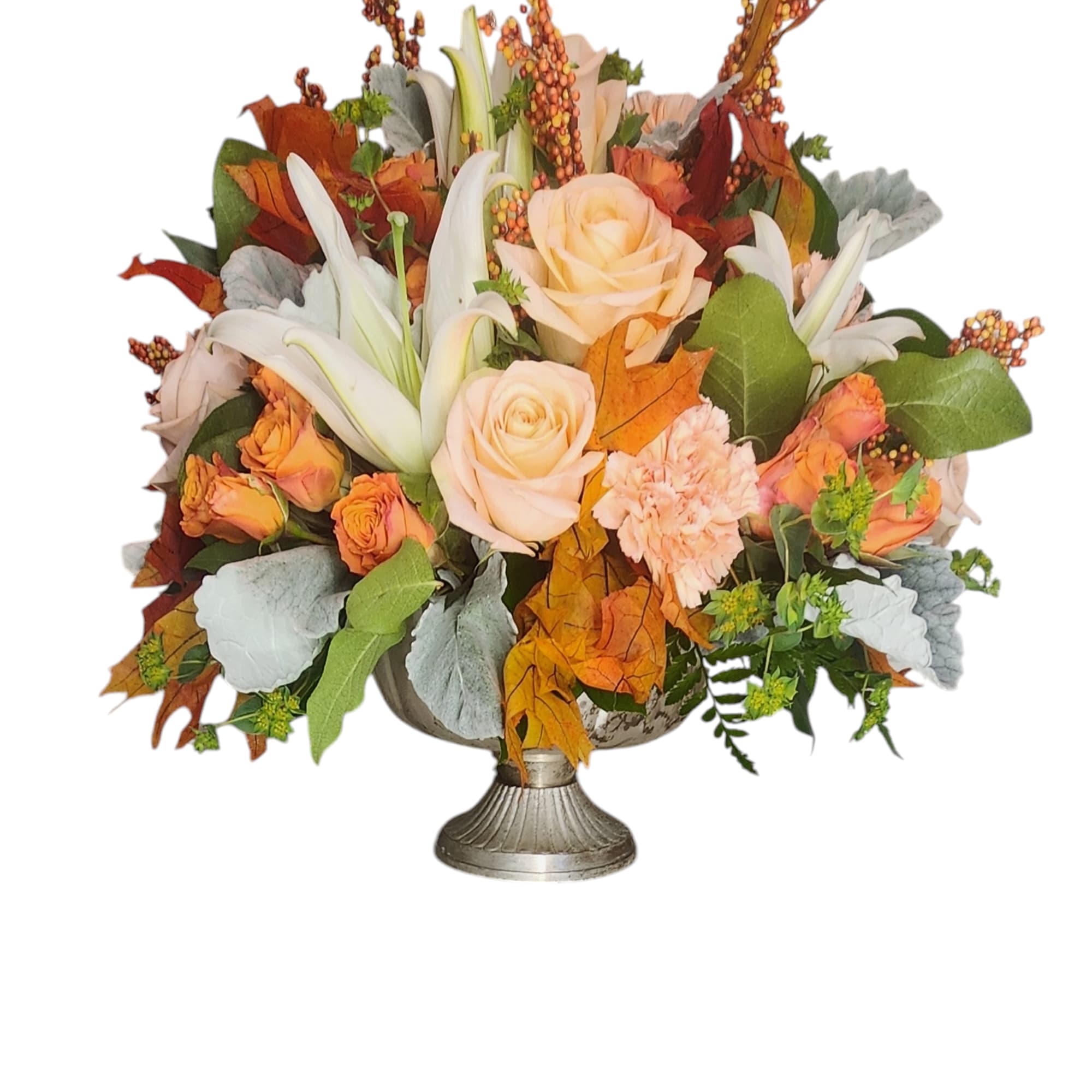 Autumn floral arrangement with peach roses and white lilies in a silver vase