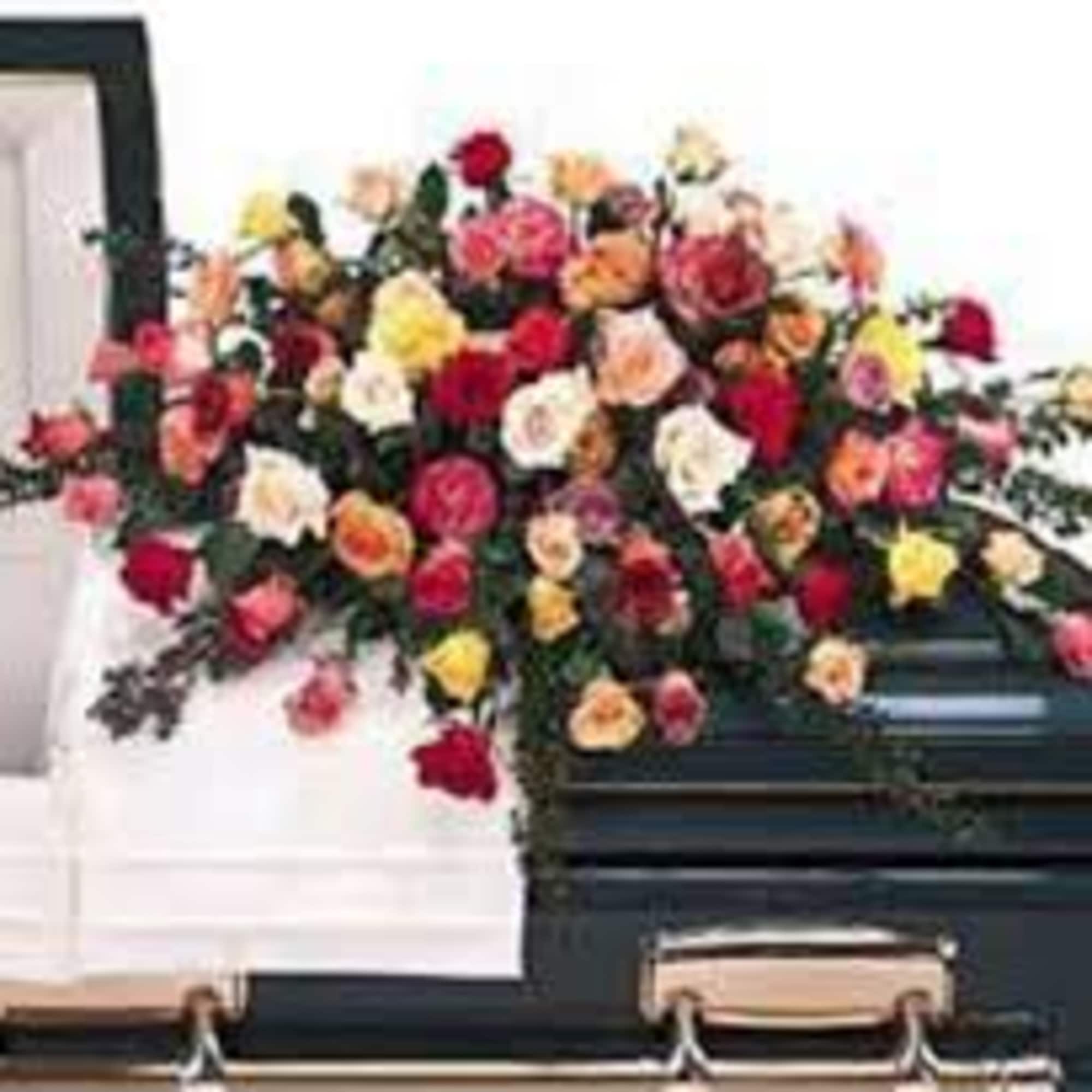 Colorful rose casket spray with mixed blooms