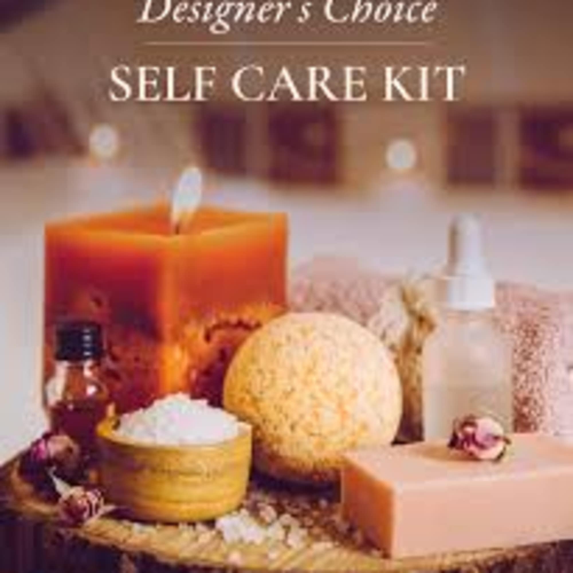 Self care kit with candle, lotion, and bath items on a tray