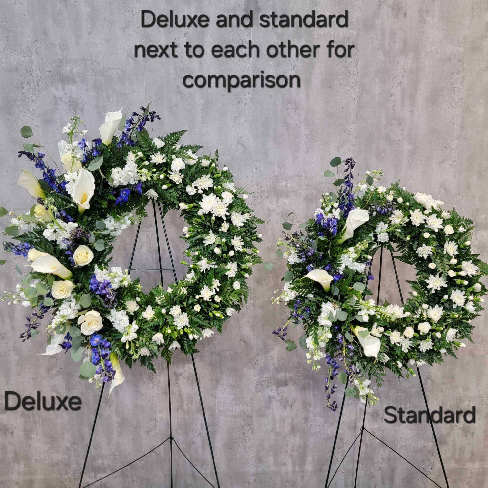 Two floral wreaths on stands, one labeled Deluxe and one Standard