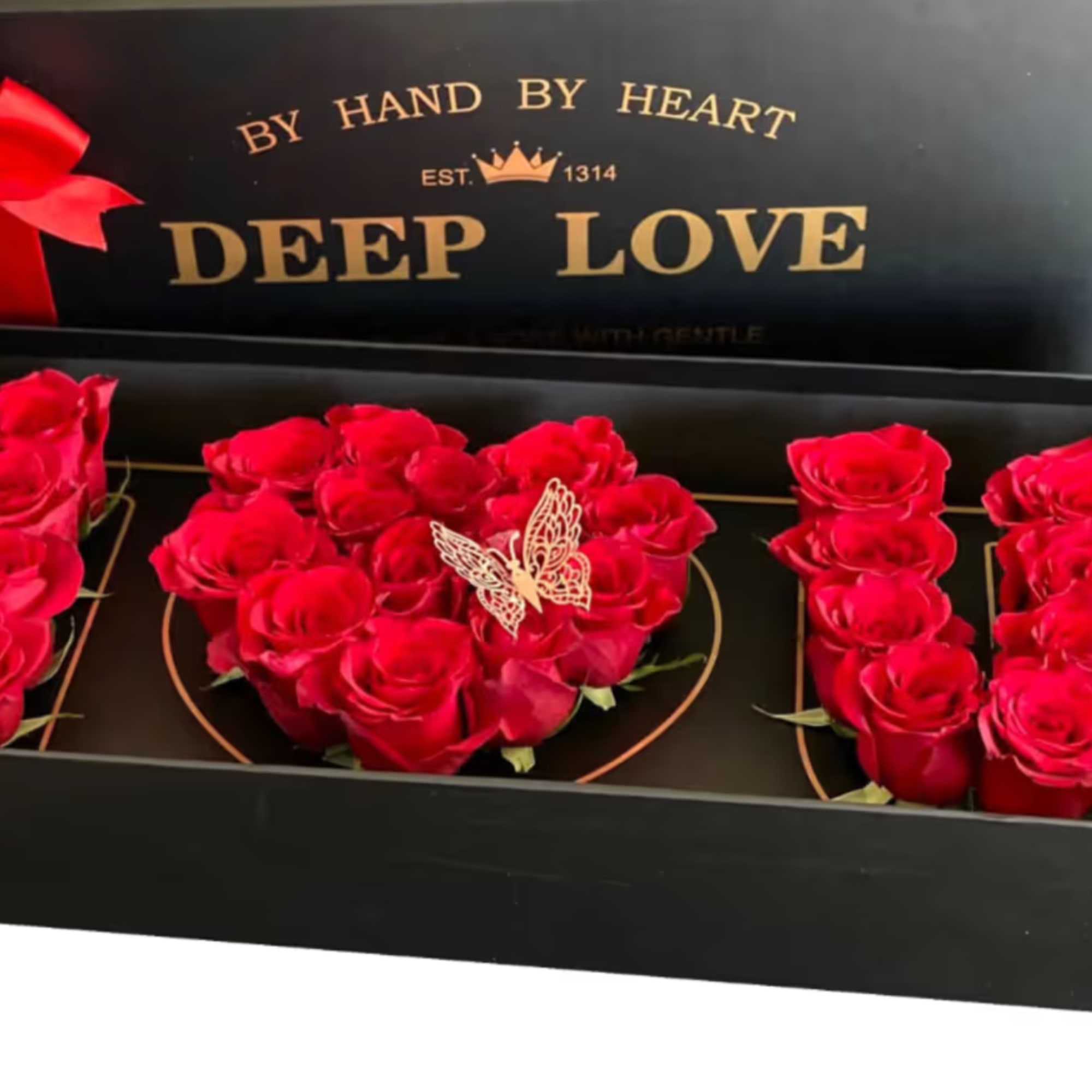 Red roses arranged in a black gift box with a ribbon