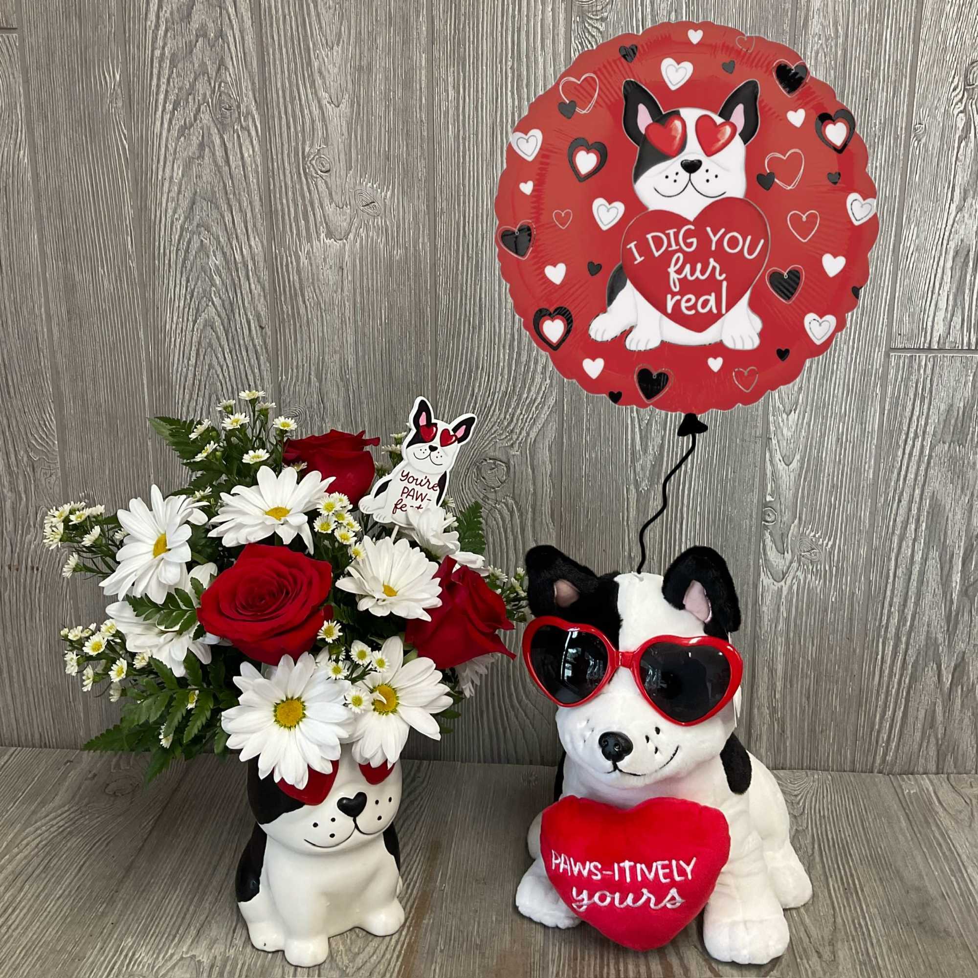 Bouquet of red roses and white daisies in a dog-shaped vase with a heart balloon