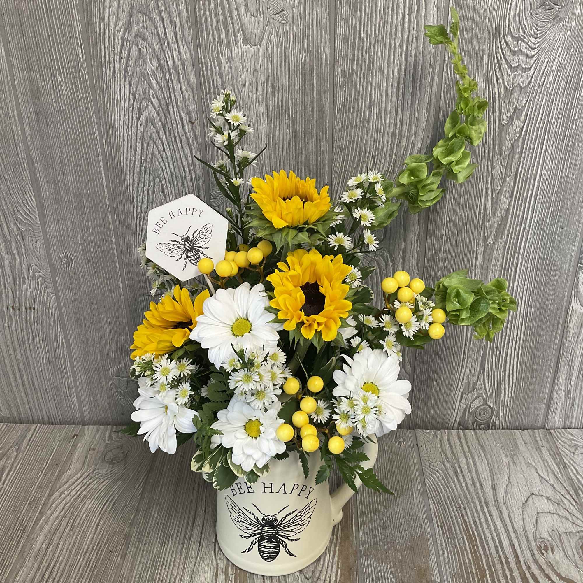 Beautiful arrangement of fresh cut flowers in a keepsake ceramic bee pitcher., photo 2 of 3