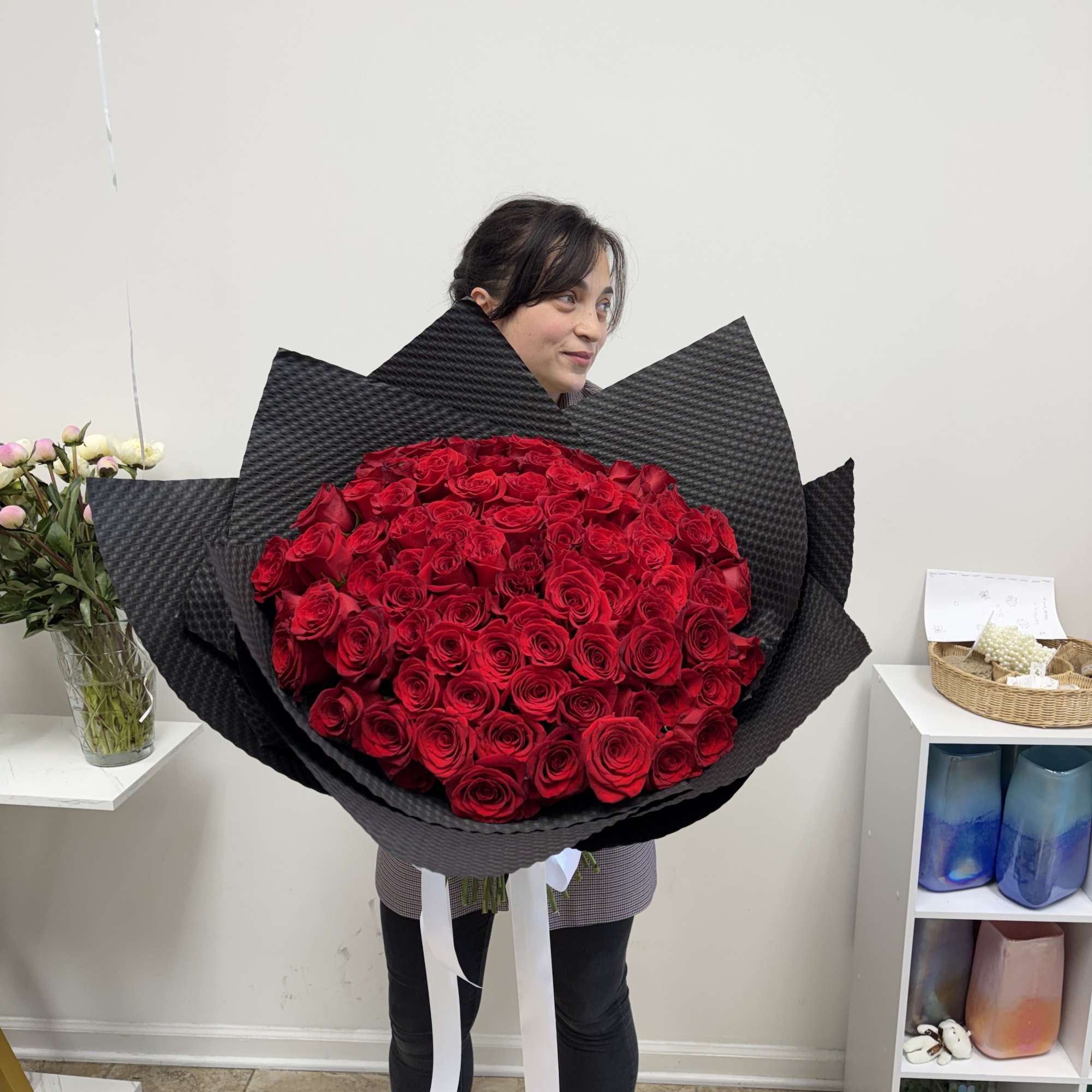 Large bouquet of red roses wrapped in black paper