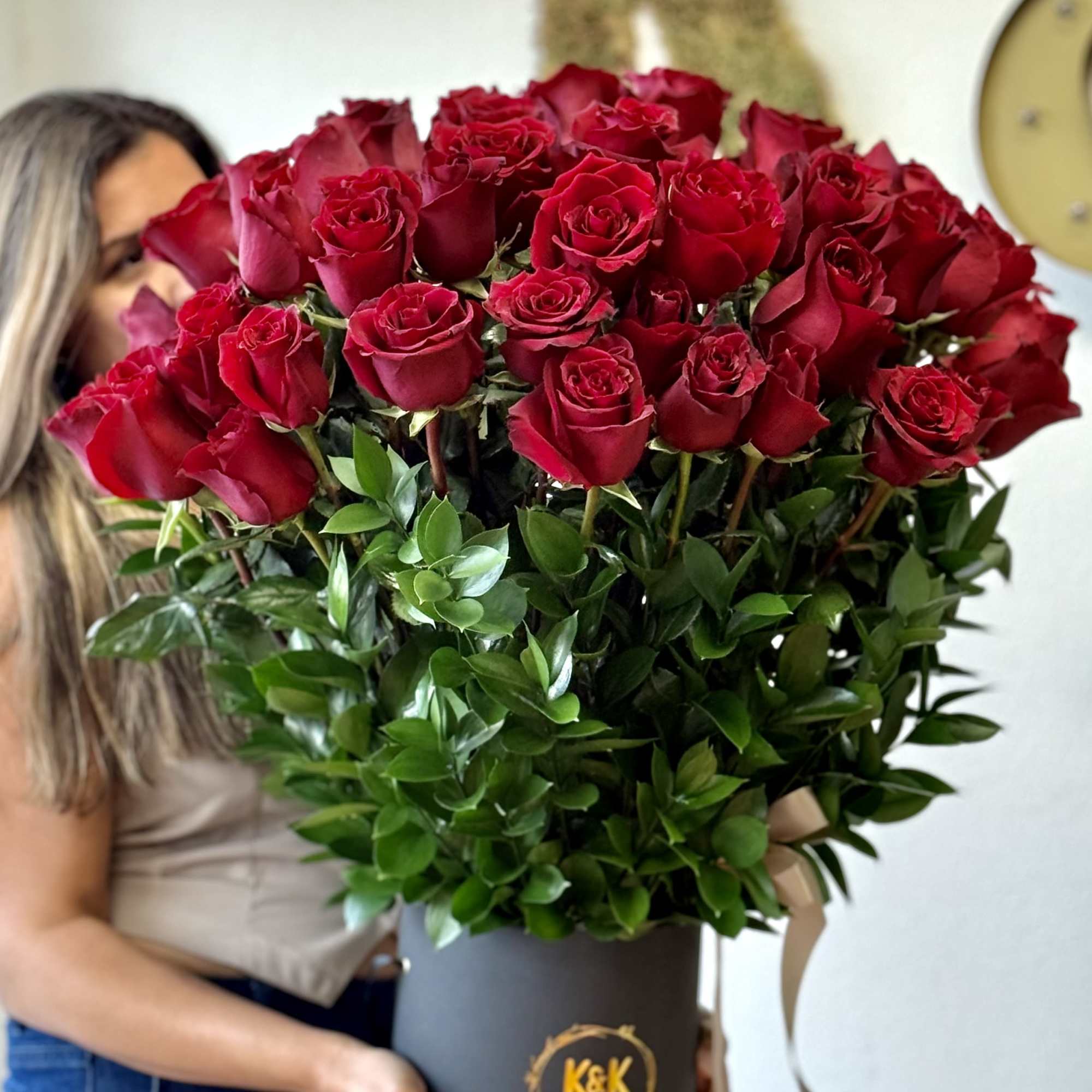 Large bouquet of red roses in a black hat box