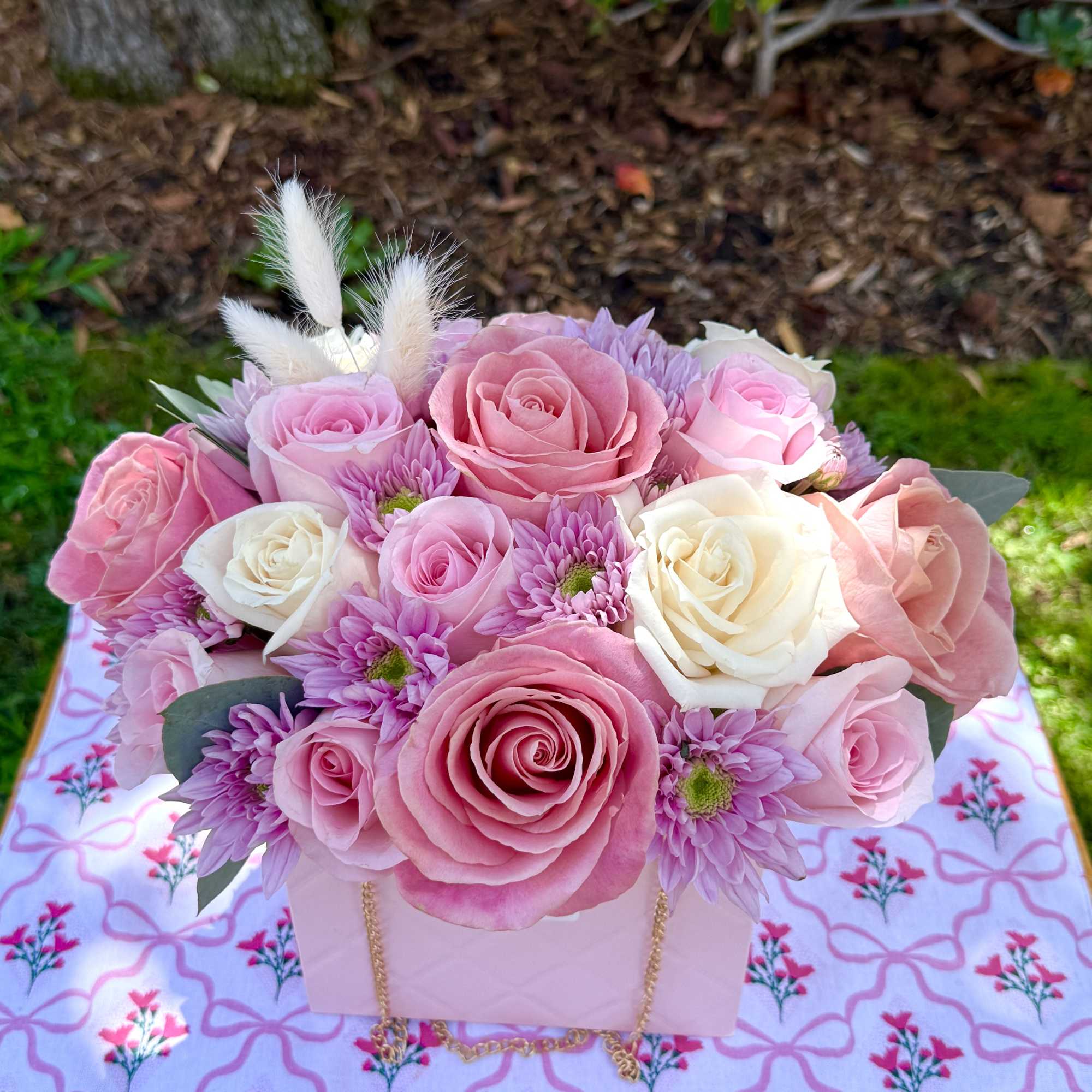 Pink and white rose bouquet with lavender daisies in a pale box