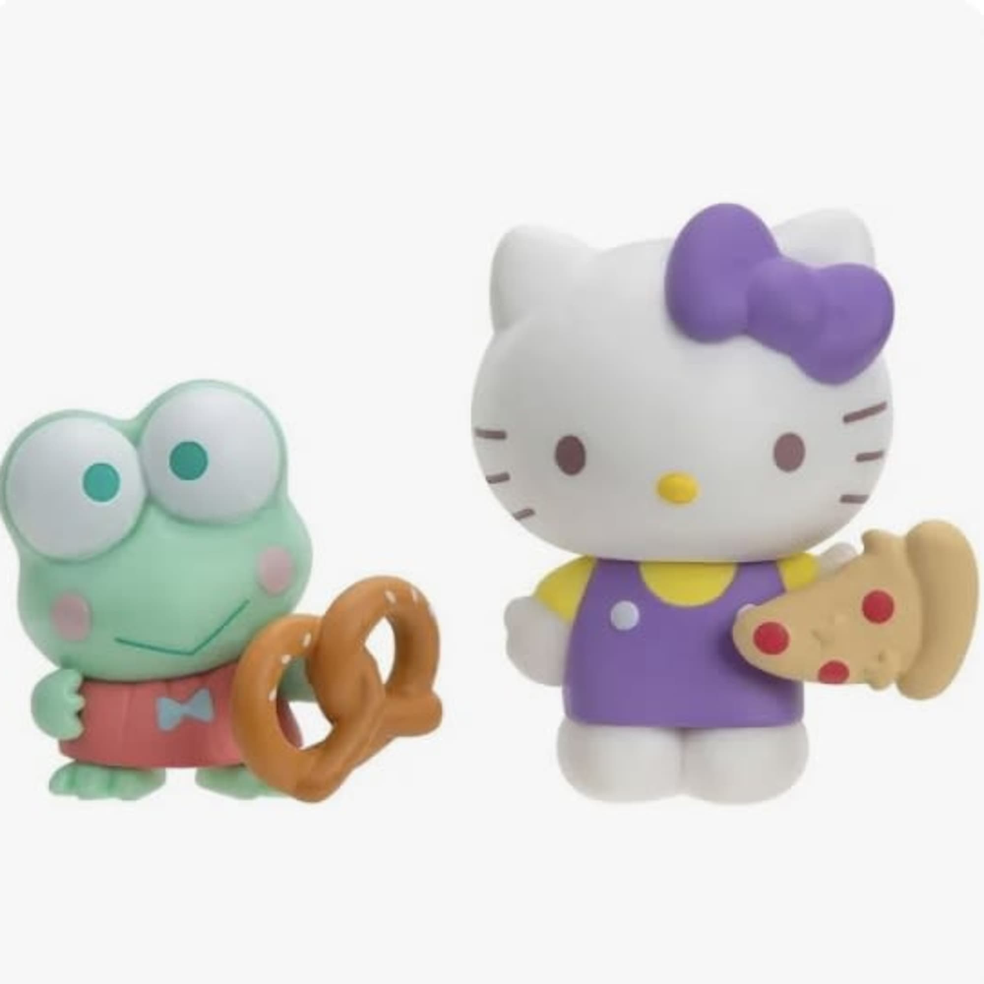 Two Hello Kitty character figurines holding snacks