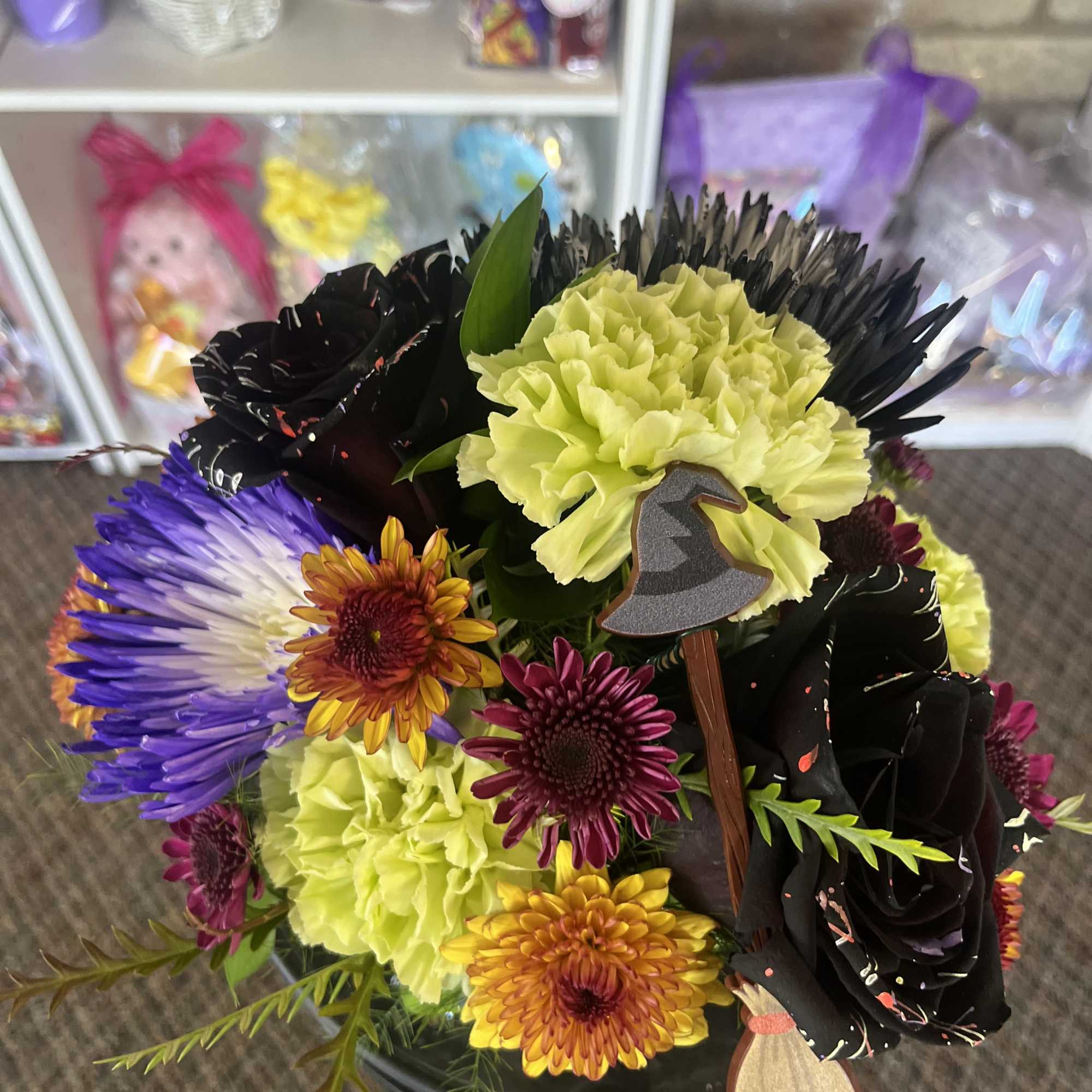 Mixed bouquet with black roses, lime carnations, and purple chrysanthemums