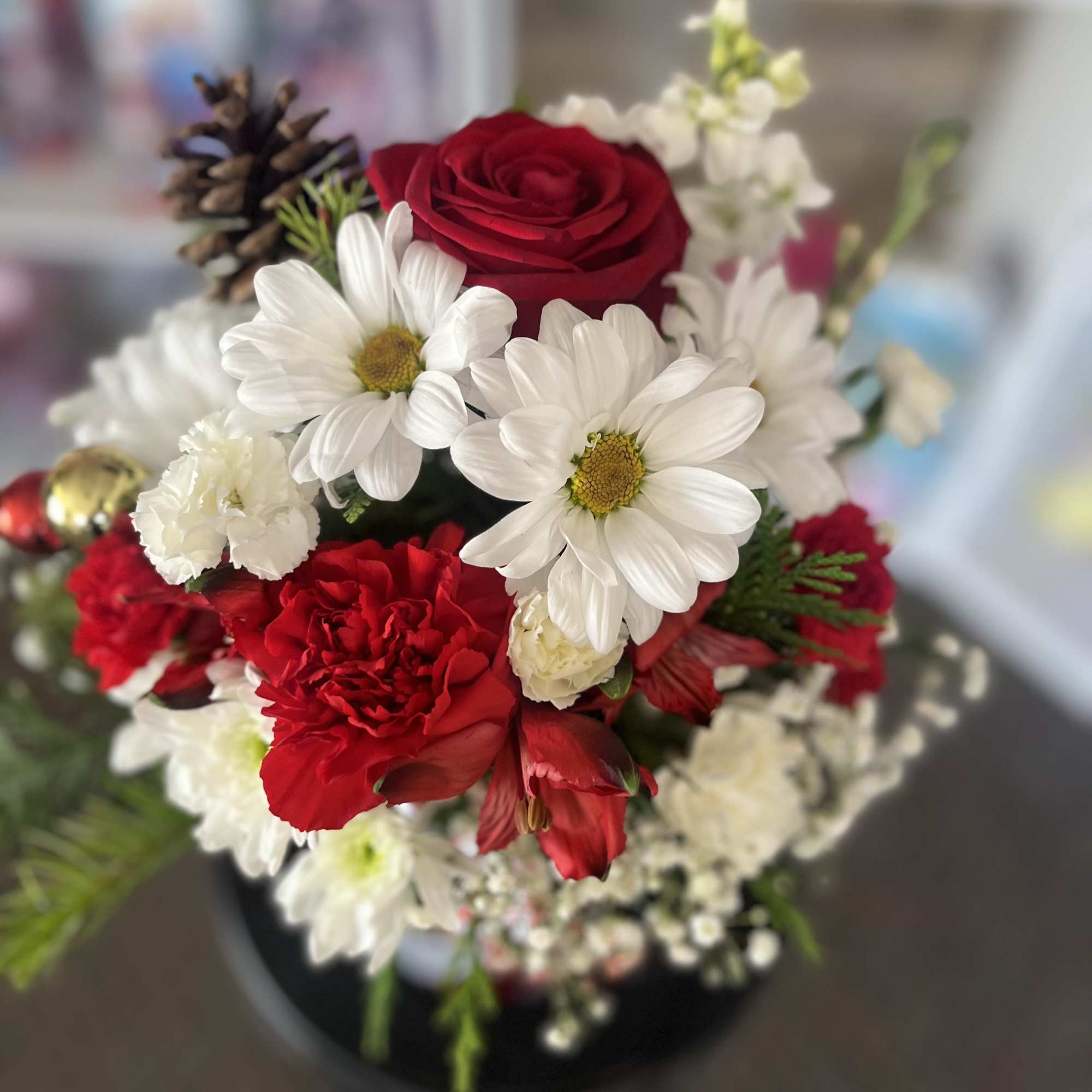 Bouquet of red roses, white daisies, and red carnations