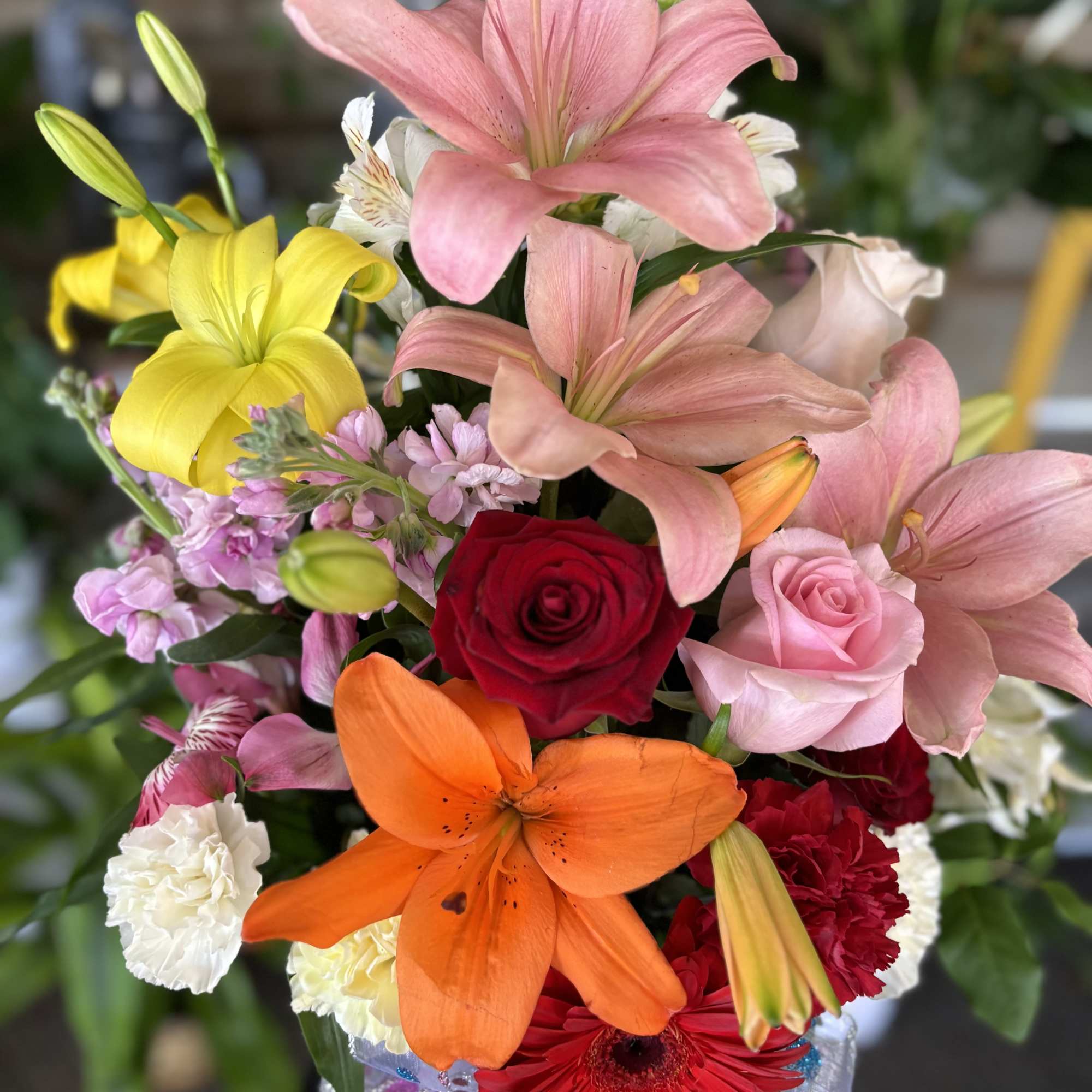 Colorful bouquet with lilies, roses, carnations, and a gerbera daisy