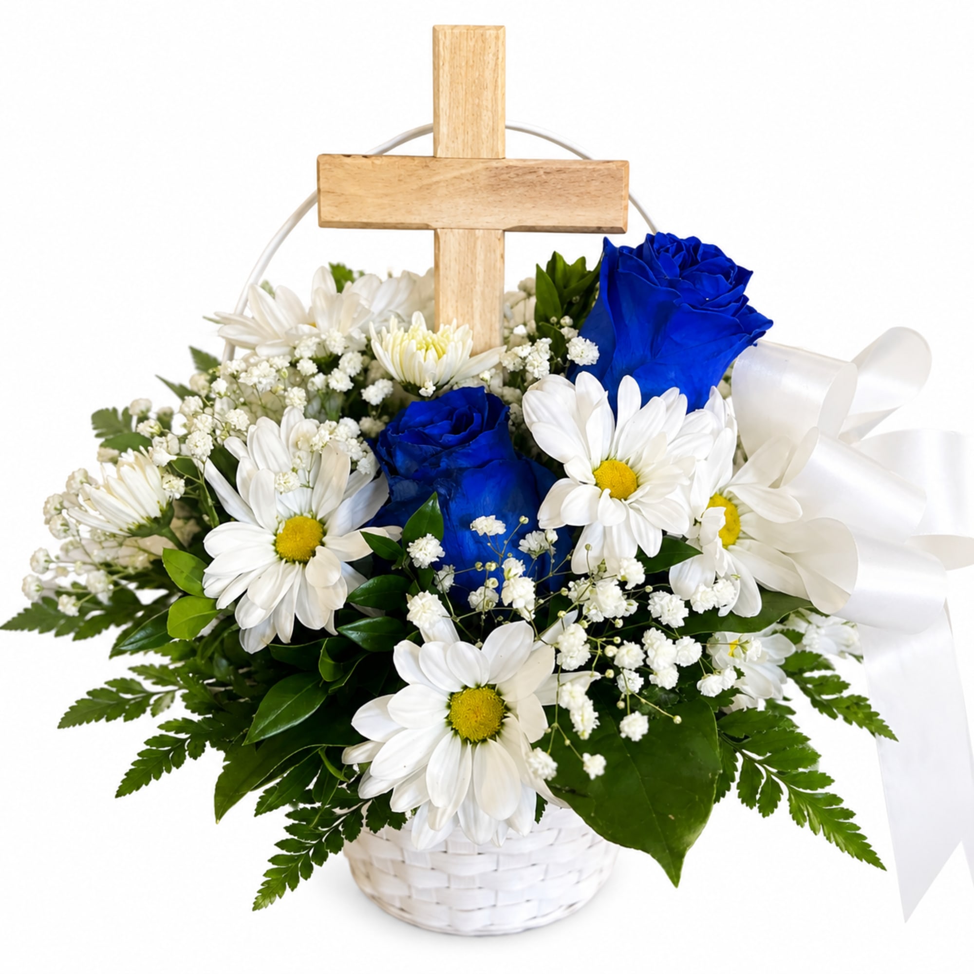 White daisies and blue roses arranged in a basket with a wooden cross