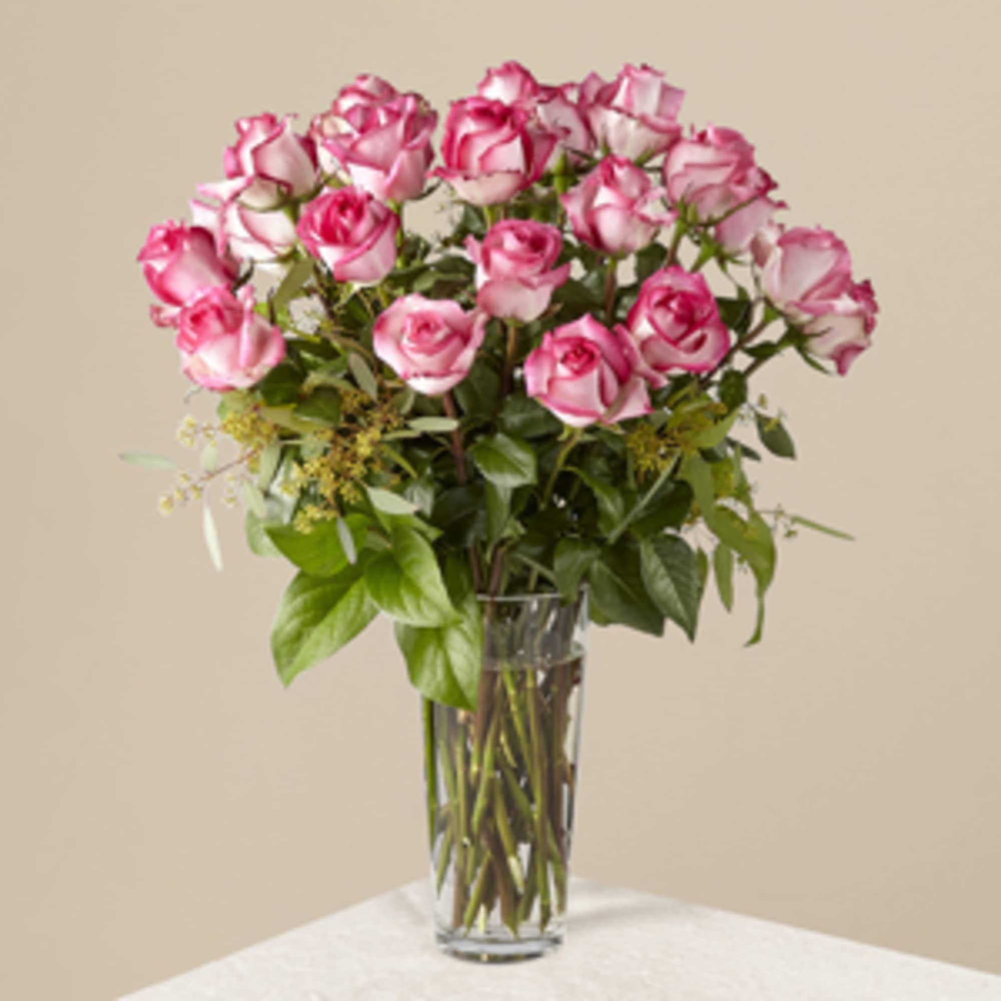 Pink roses arranged in a clear glass vase