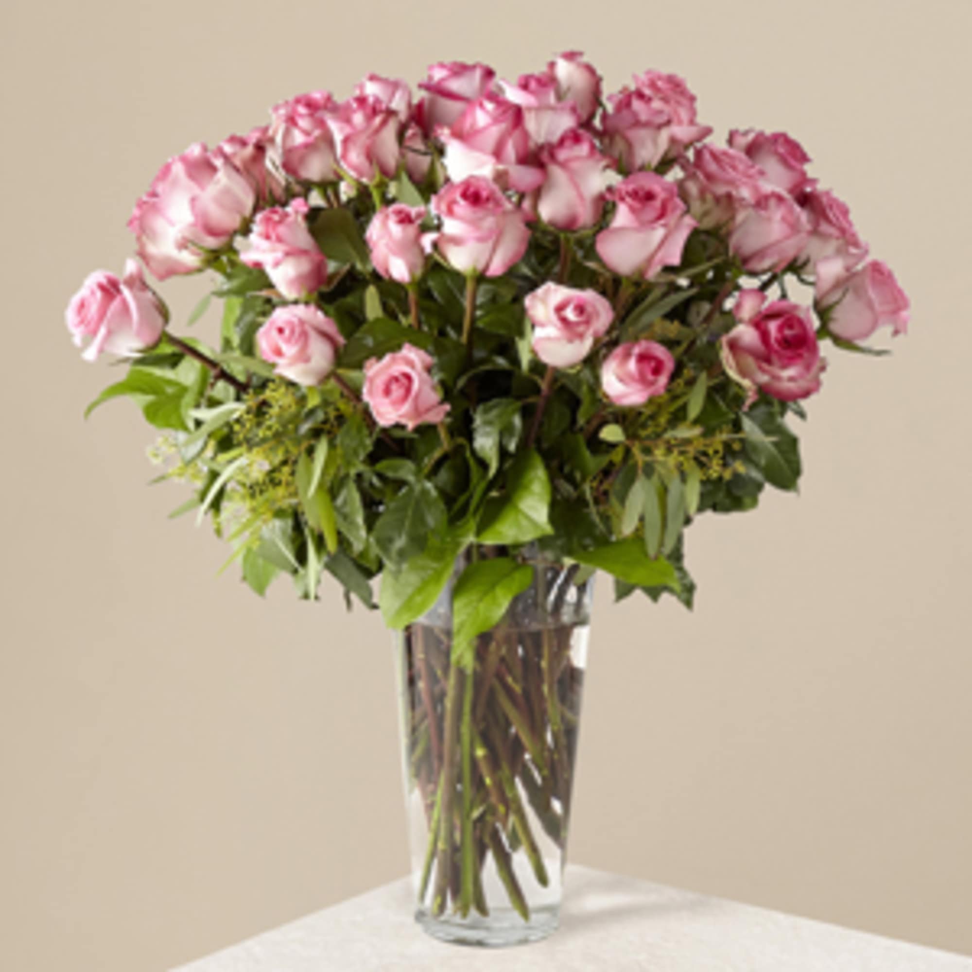 Pink roses arranged in a clear glass vase