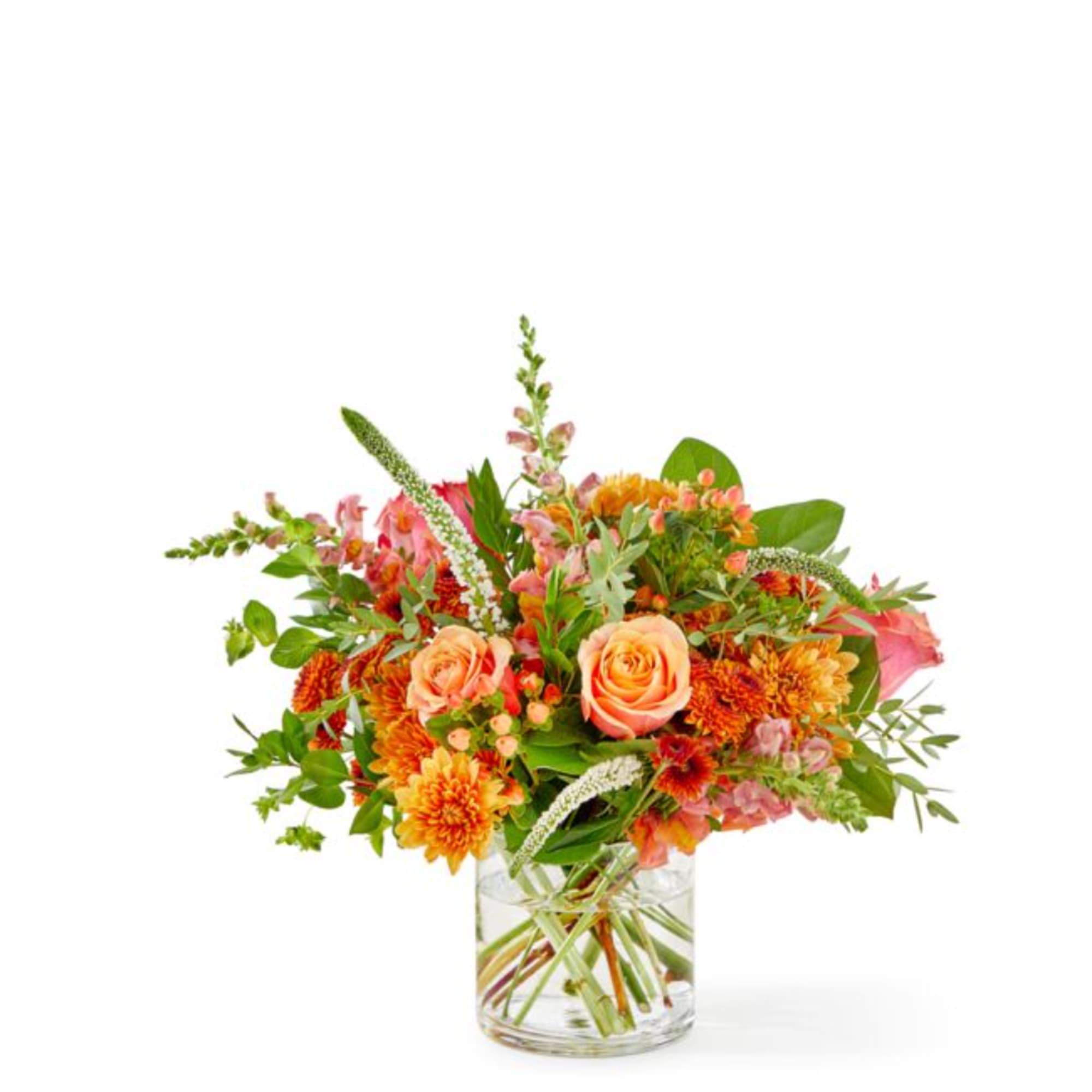 Orange and pink mixed bouquet in a clear glass vase