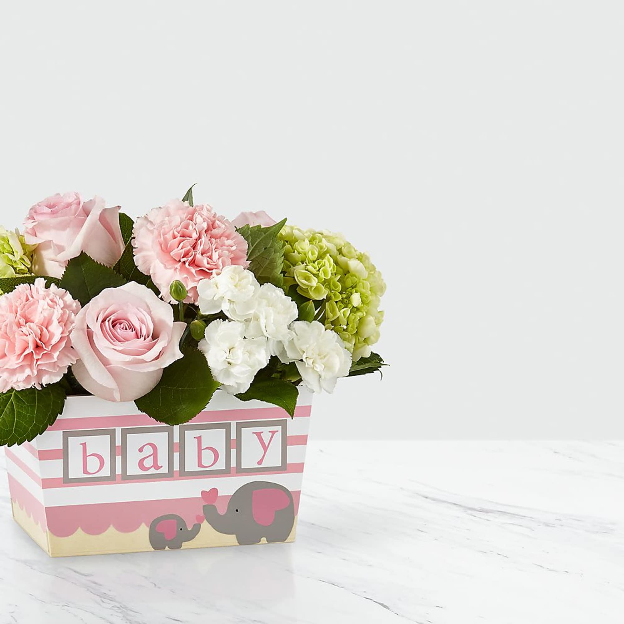 Pink and white flower arrangement in a baby-themed box