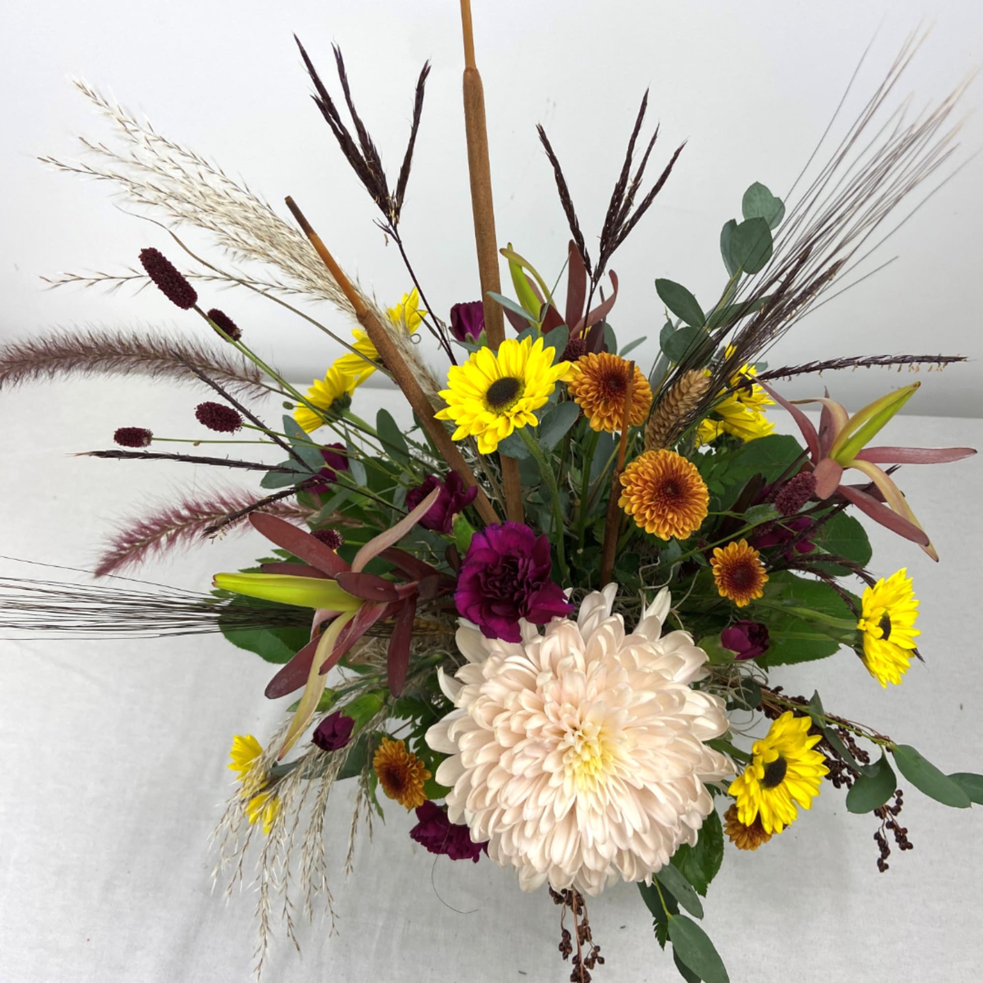 Mixed bouquet with yellow sunflowers, cream chrysanthemum, and burgundy accents