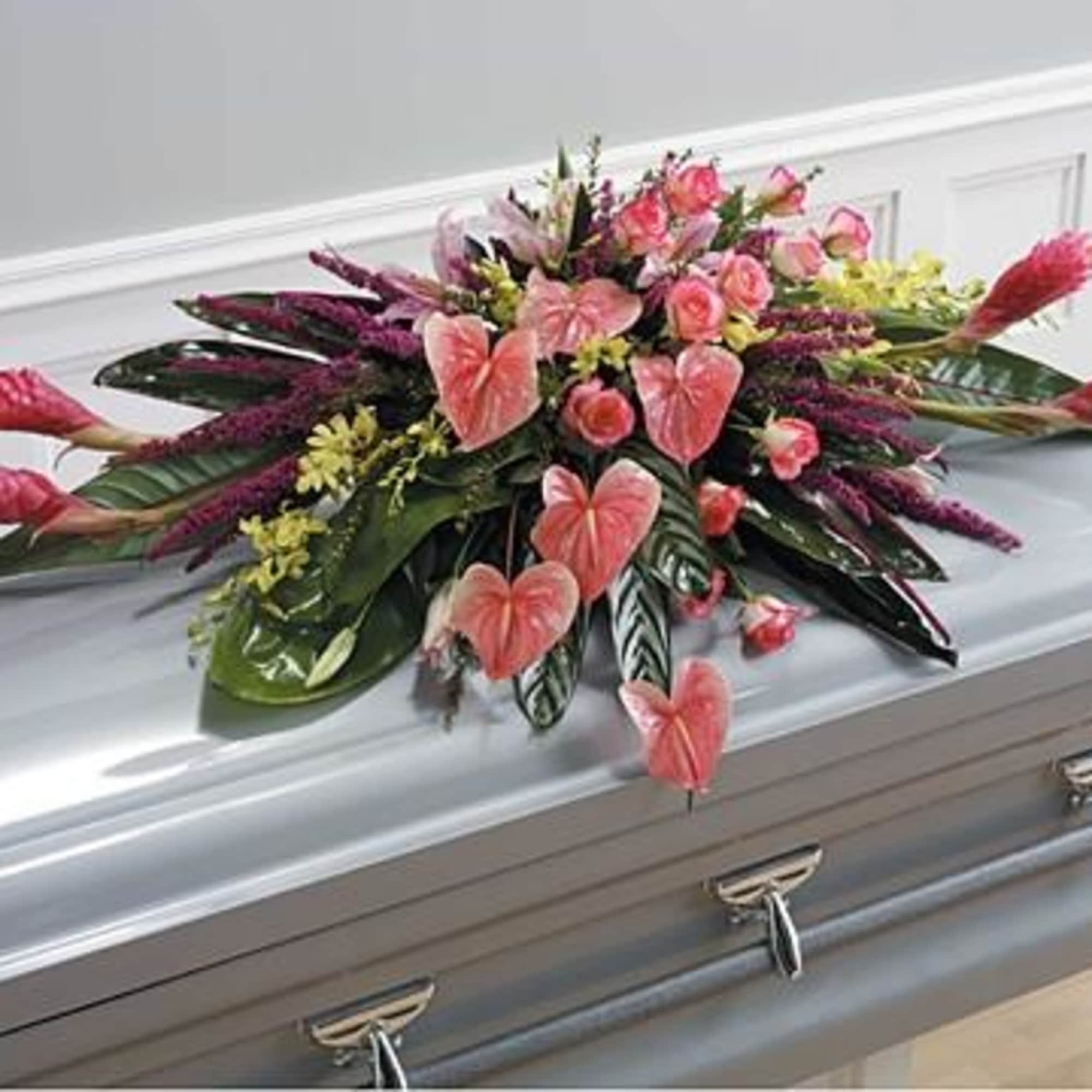 Red ginger, roses, orchids, anthurium, tropical foliage and touches of filler flowers.
