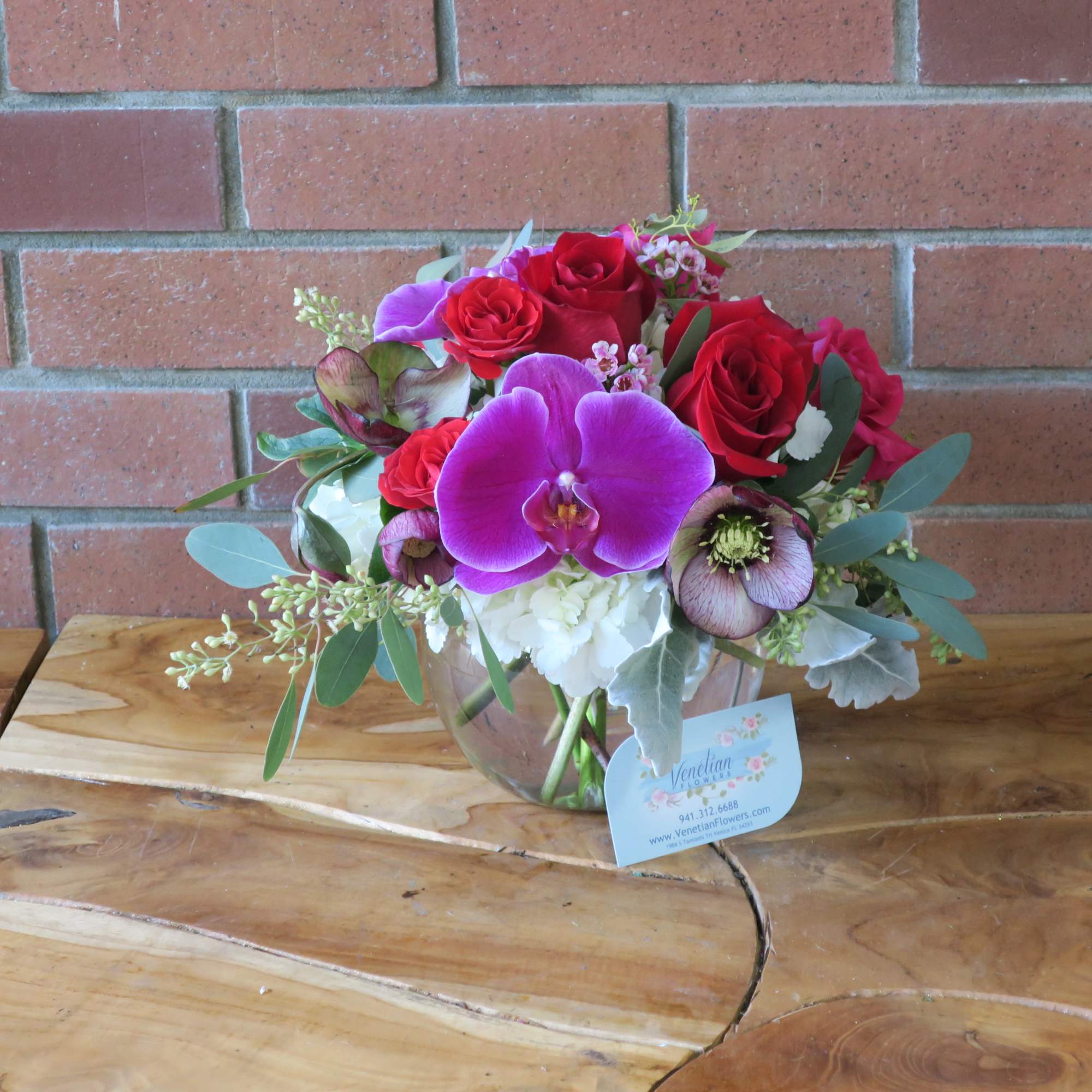 Bouquet of red roses and purple orchids in a glass vase, photo 2 of 2