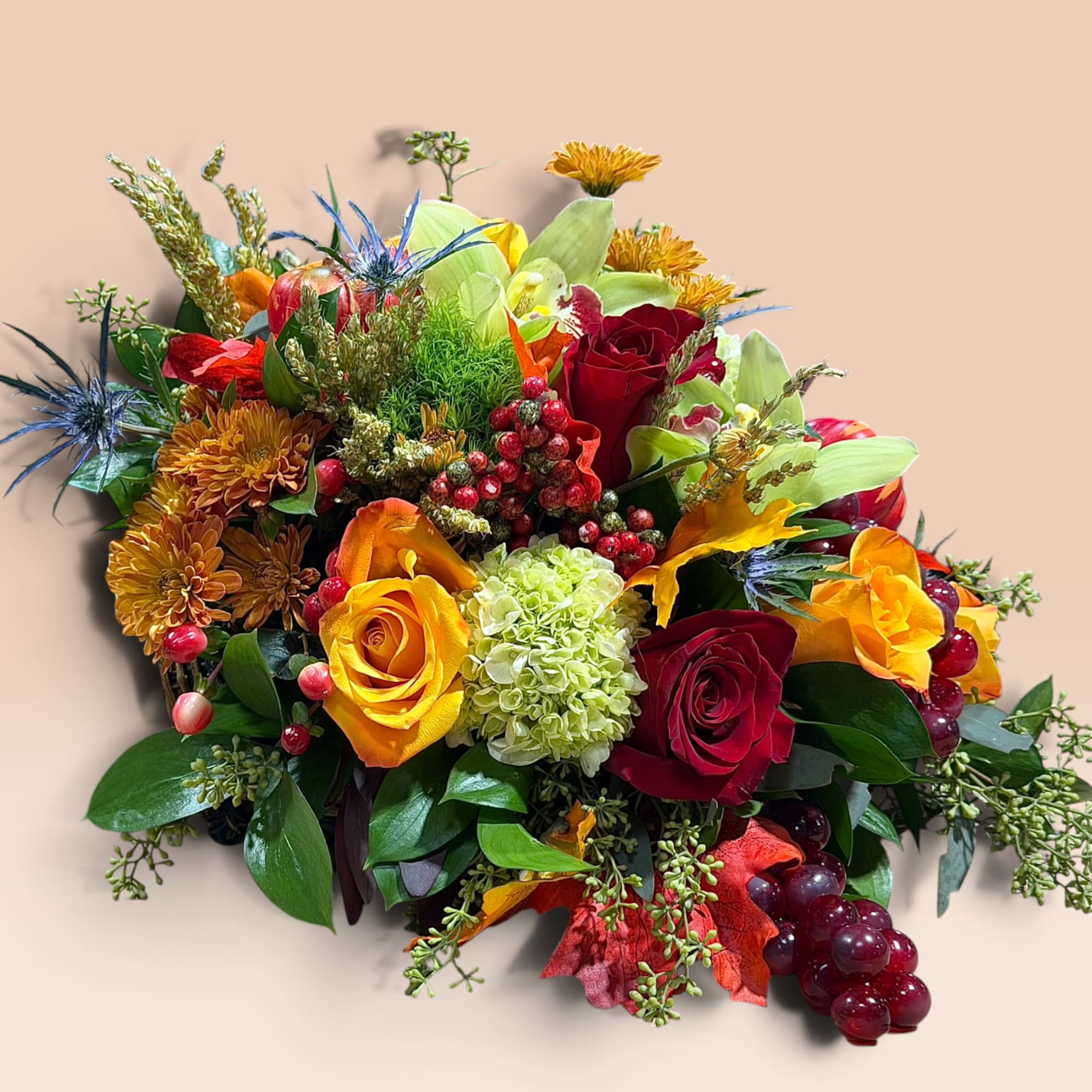 Mixed bouquet with red and yellow roses, chrysanthemums, and berries