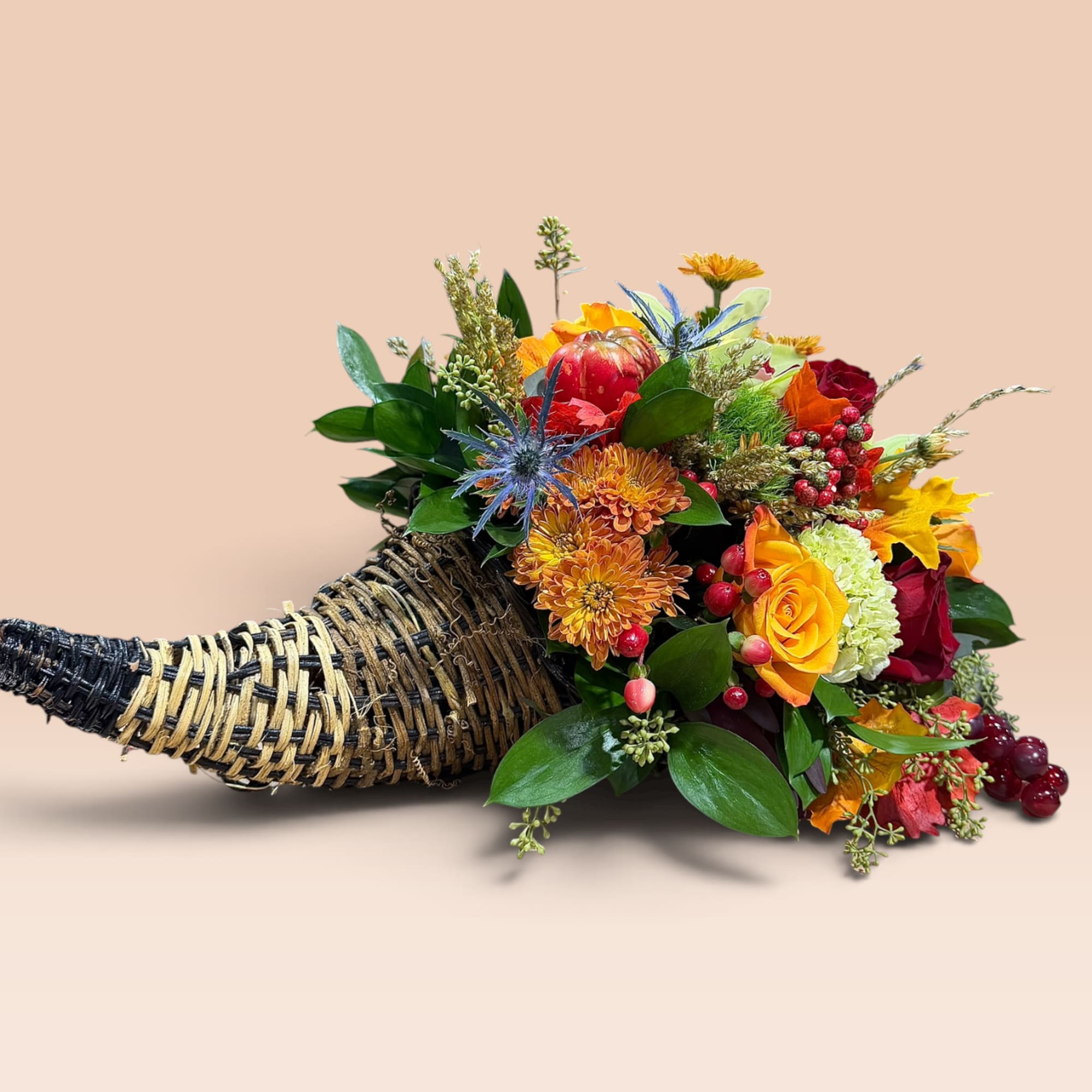 Horn-shaped basket filled with colorful flowers and berries