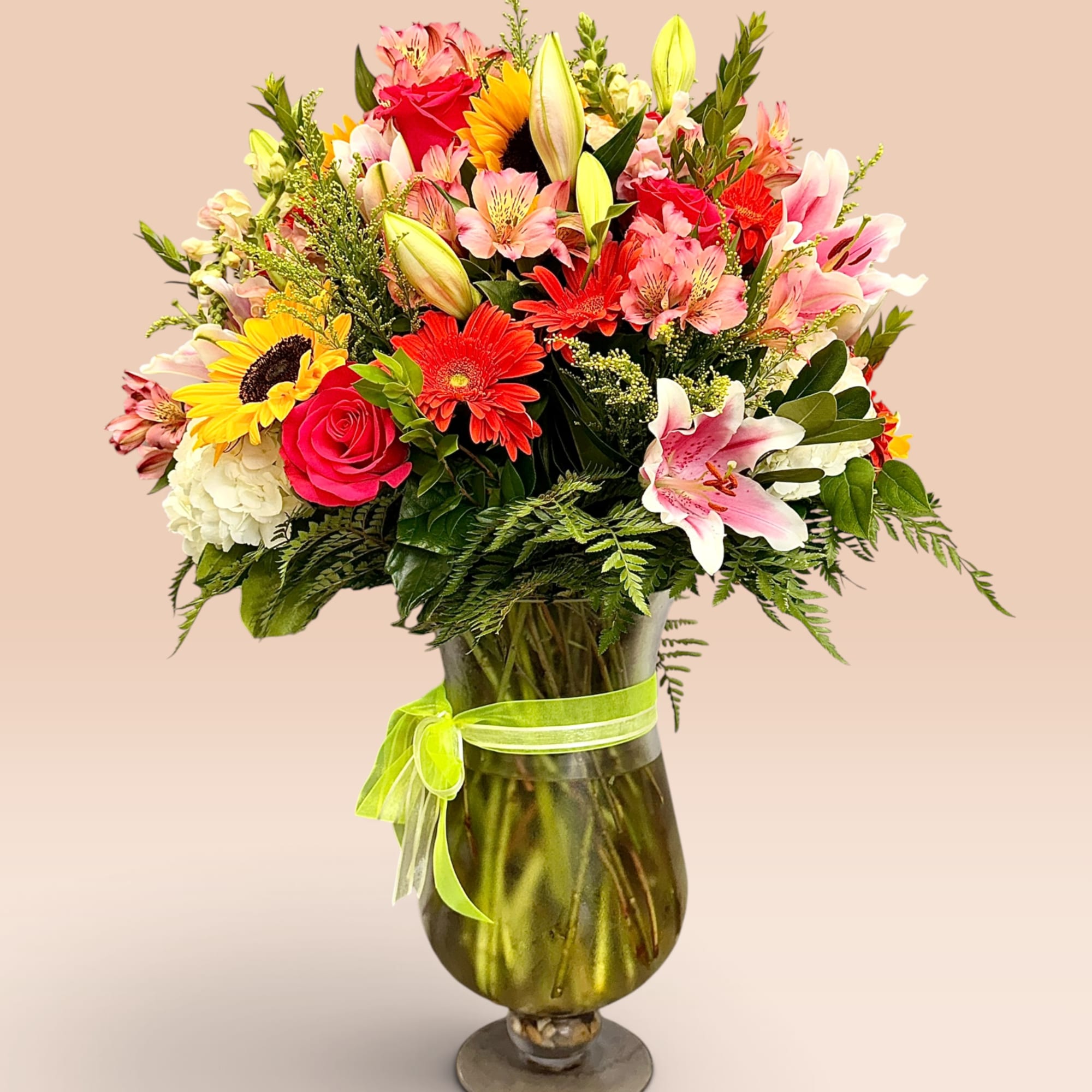 Mixed bouquet in a glass vase with a lime ribbon