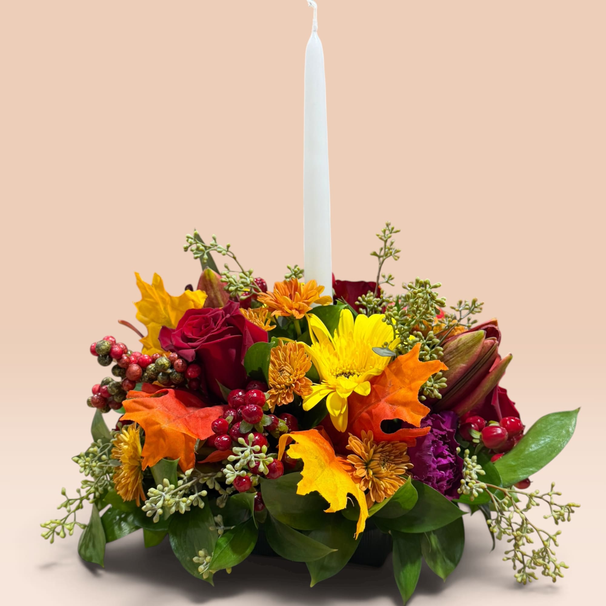 Autumn floral centerpiece with a white taper candle