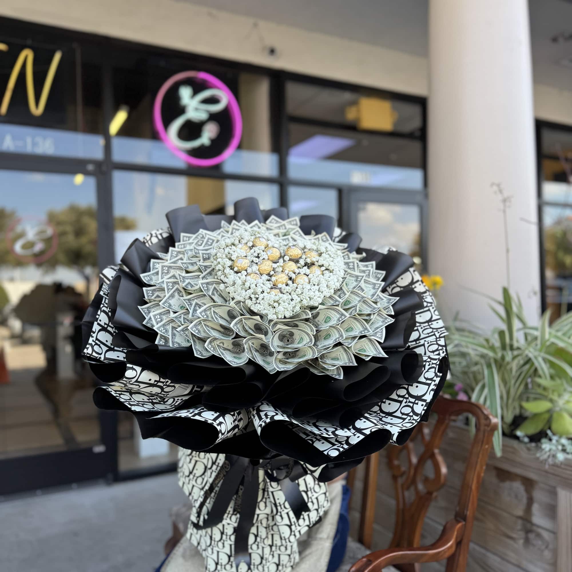 Large bouquet made of folded dollar bills with white filler and gold accents